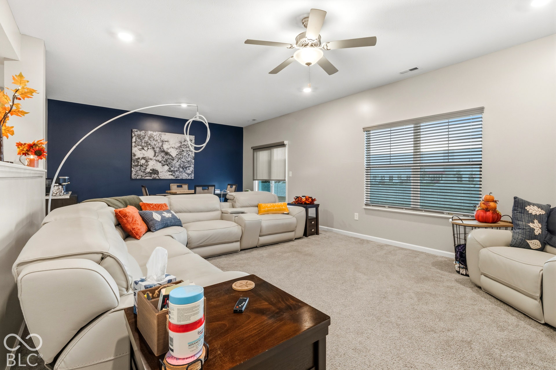 Recessed ceiling lighting, ceiling fan fixture, window with blinds, carpeted flooring, and a contrasting accent wall