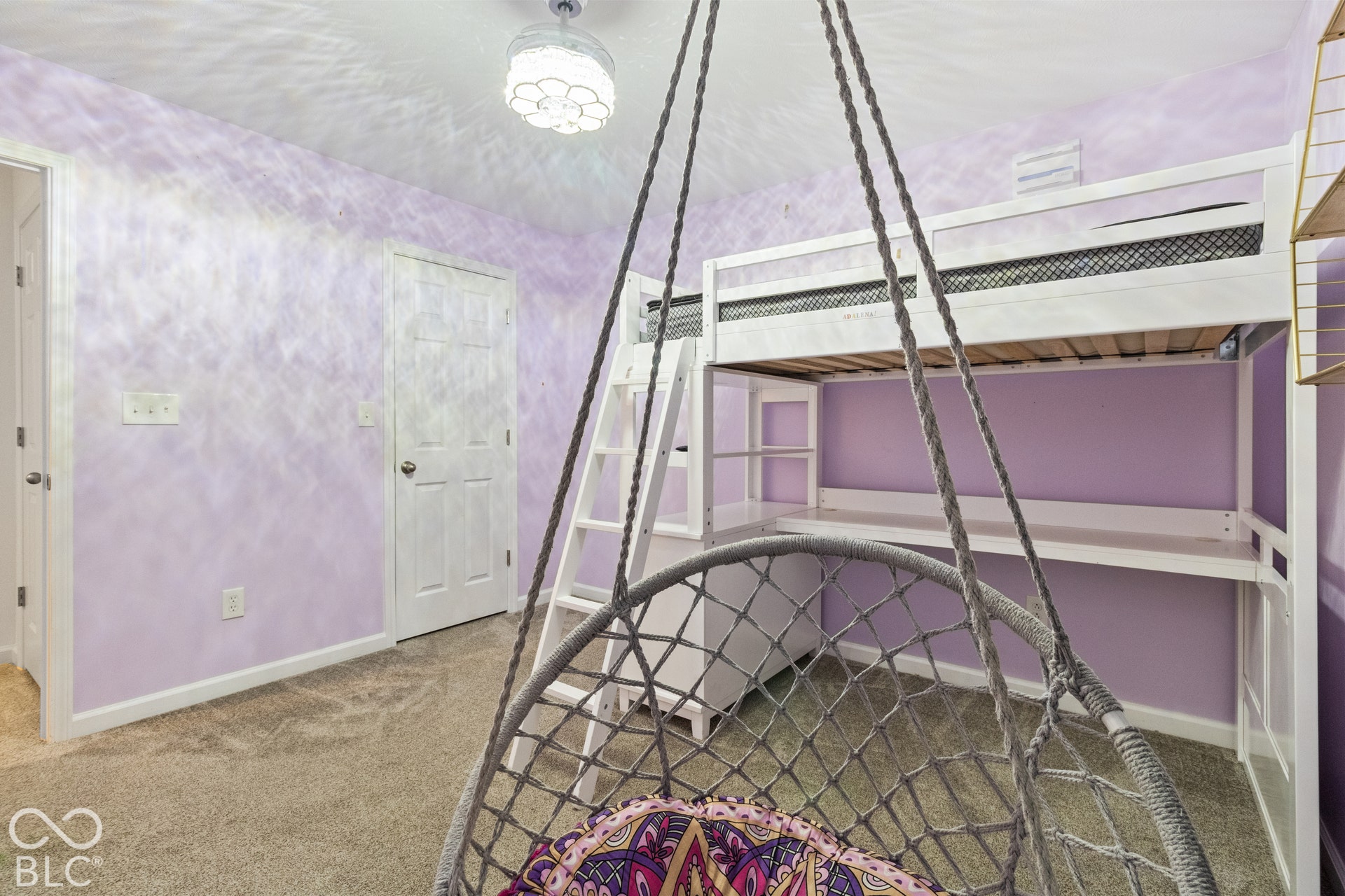 Carpeted flooring, ceiling-mounted light fixture, white interior door, and built-in white bunk bed with integrated desk