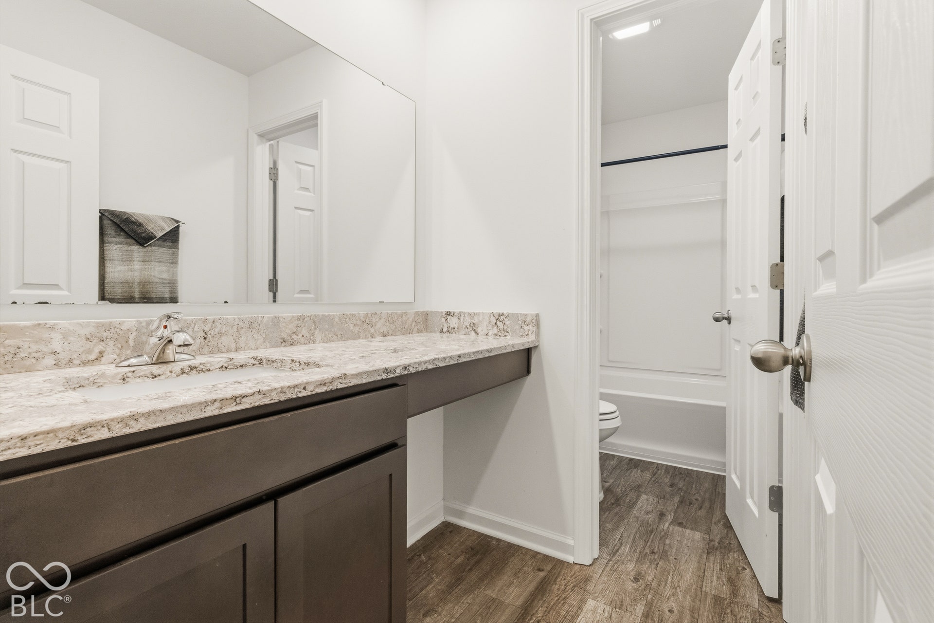 Extended vanity with an integrated sink and a stone-finish countertop
