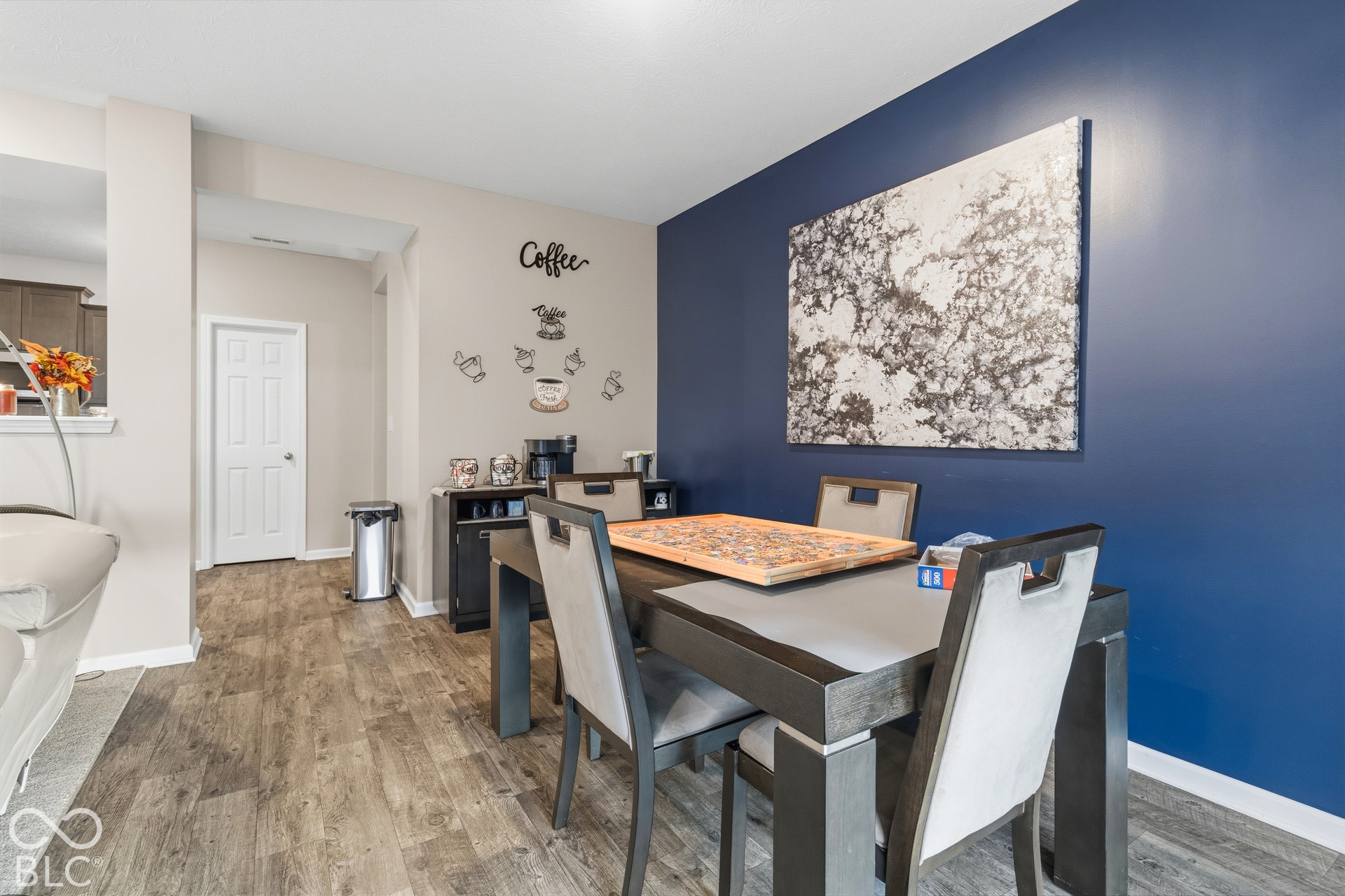 Wood-finish flooring throughout, with a contrasting accent wall and white trim