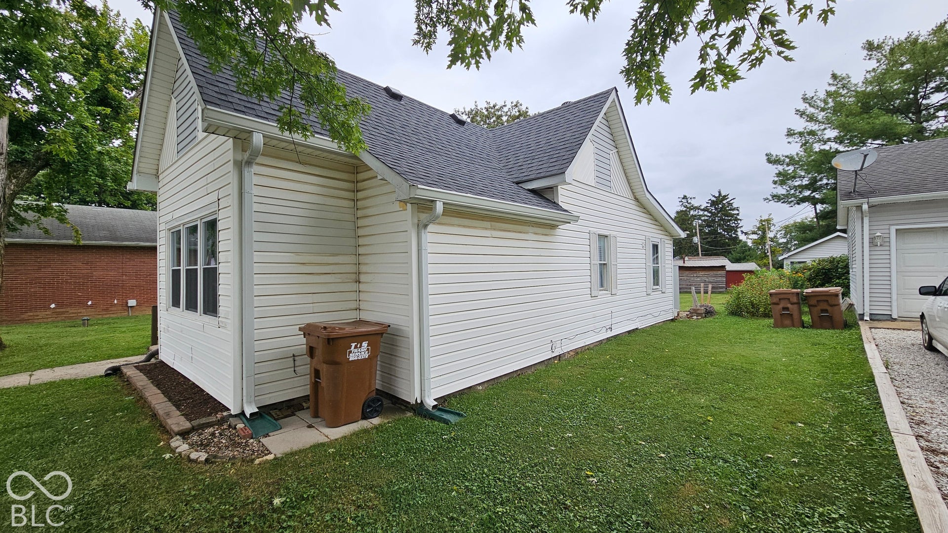 104 E State Street, New Ross, IN 47968 White siding exterior with a dark shingle roof and white gutters
