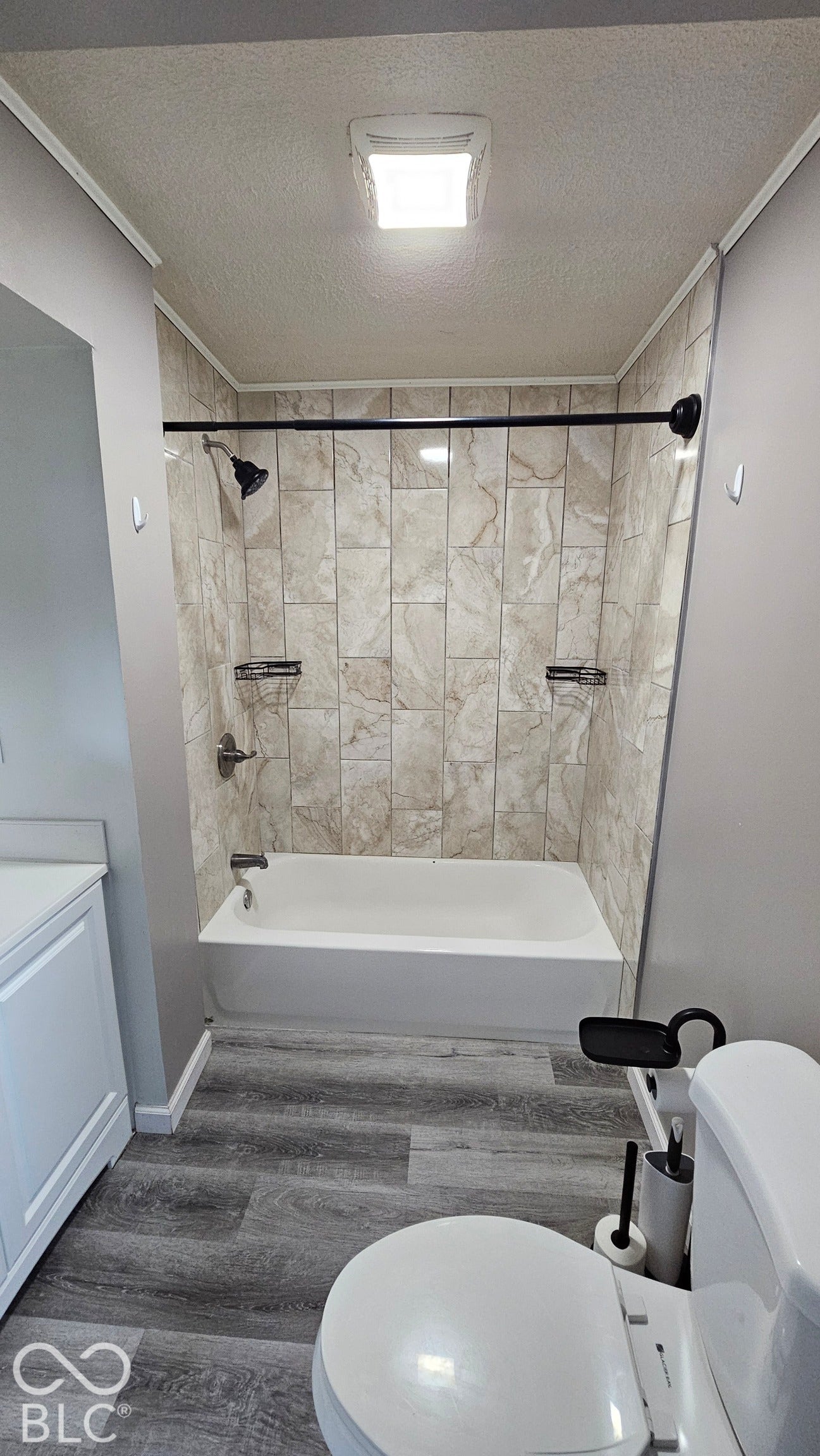 104 E State Street, New Ross, IN 47968 Bathtub with tiled surround, contemporary shower fixtures, and integrated shelving