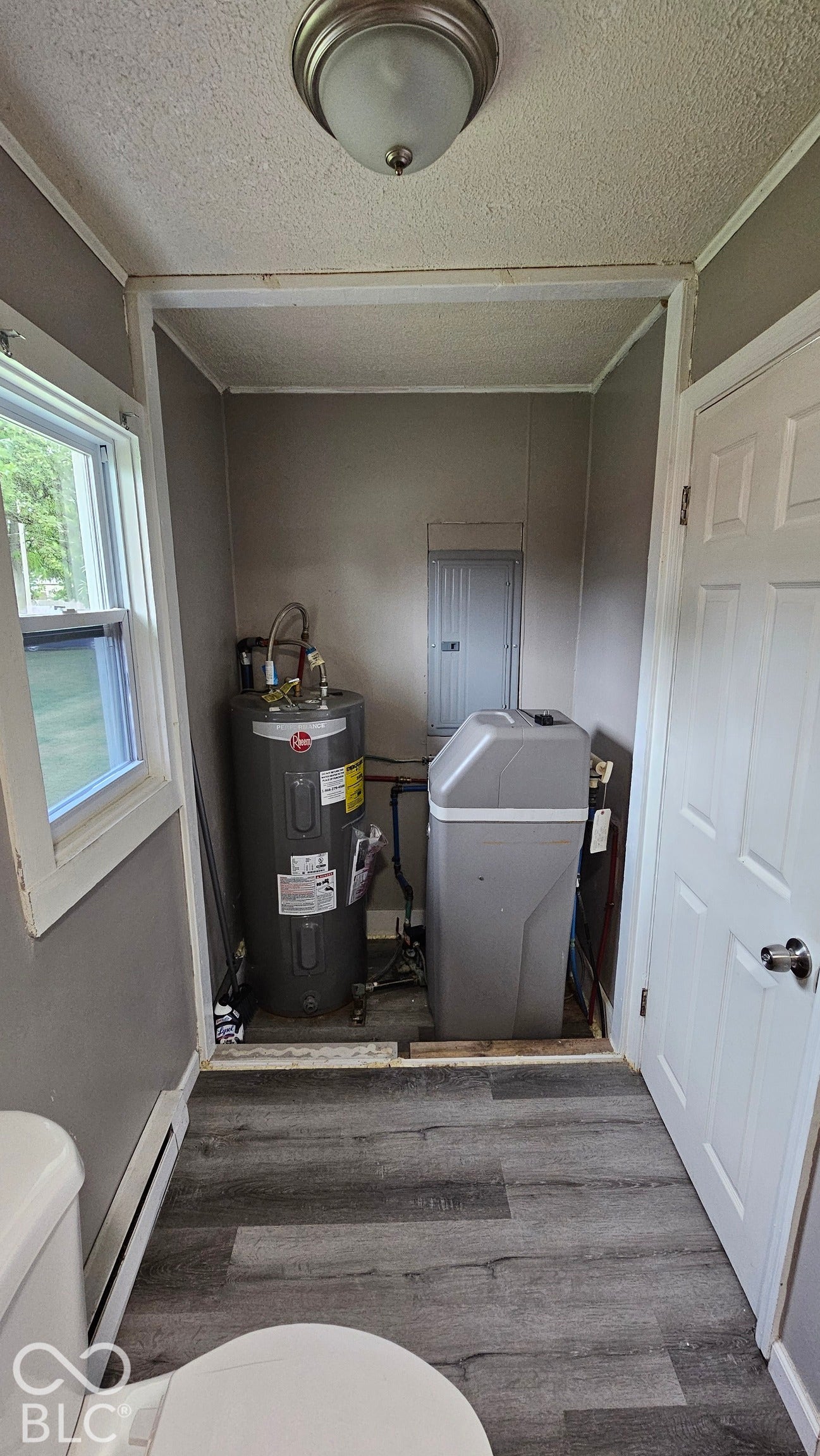 104 E State Street, New Ross, IN 47968 Wood-finish flooring, flush mount lighting, window with trim, and a white interior door