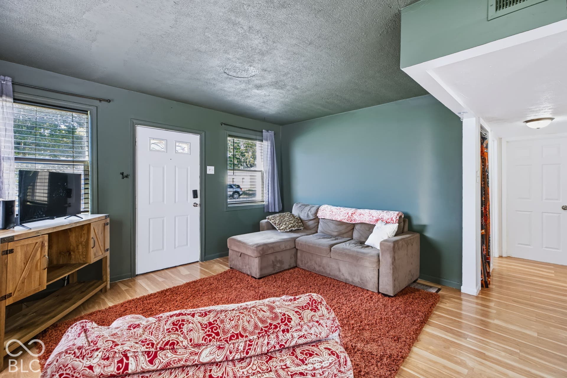 2101 Sharon Avenue, Indianapolis, IN 46222 Wood-finish flooring throughout, complemented by a solid panel entry door with decorative glass inserts