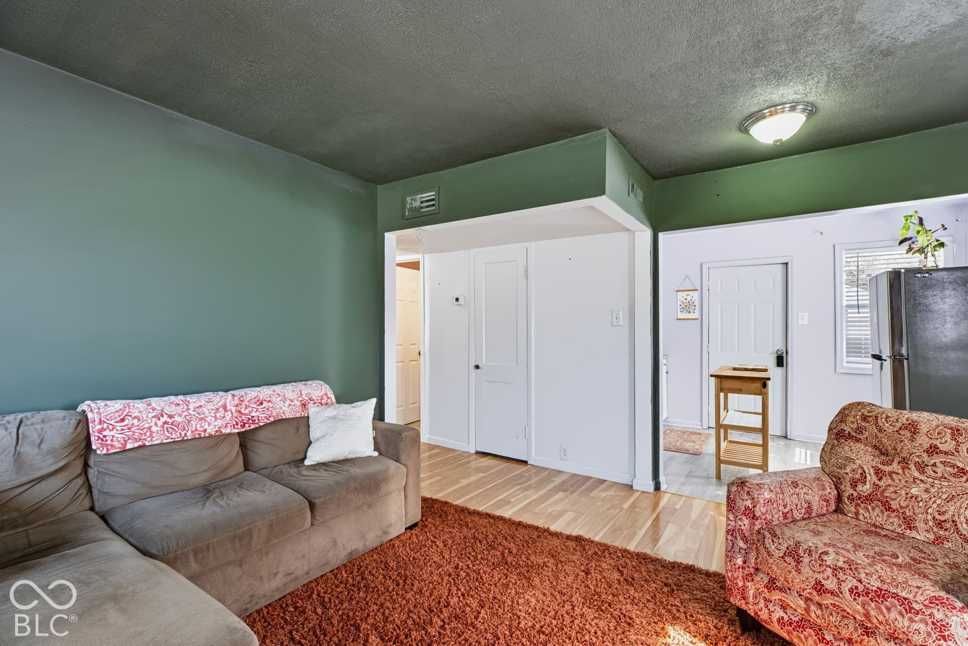 2101 Sharon Avenue, Indianapolis, IN 46222 Hardwood flooring extending from the entryway, contrasting with light-colored wall paint