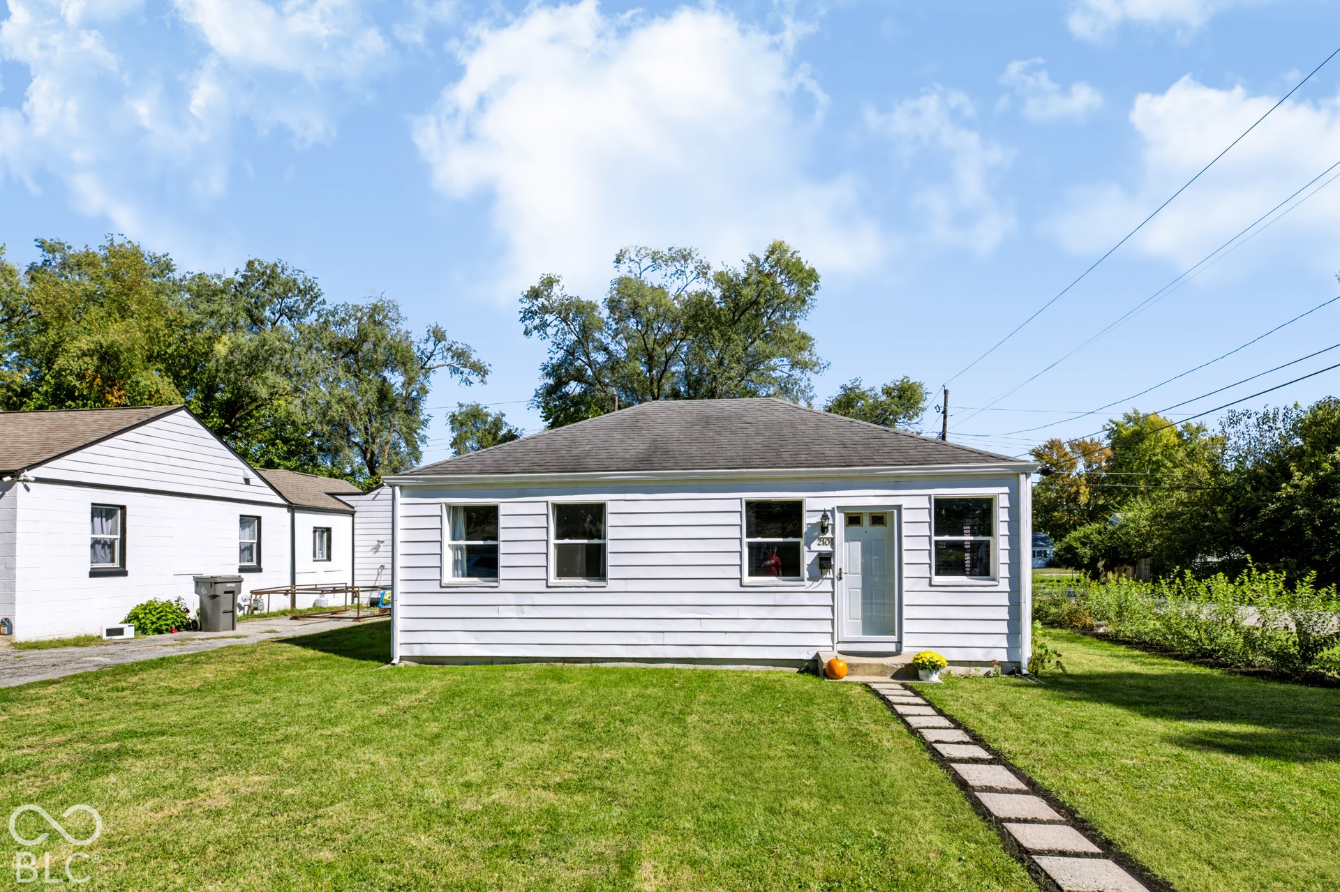 2101 Sharon Avenue, Indianapolis, IN 46222 White horizontal siding exterior with multiple windows and a front entry door