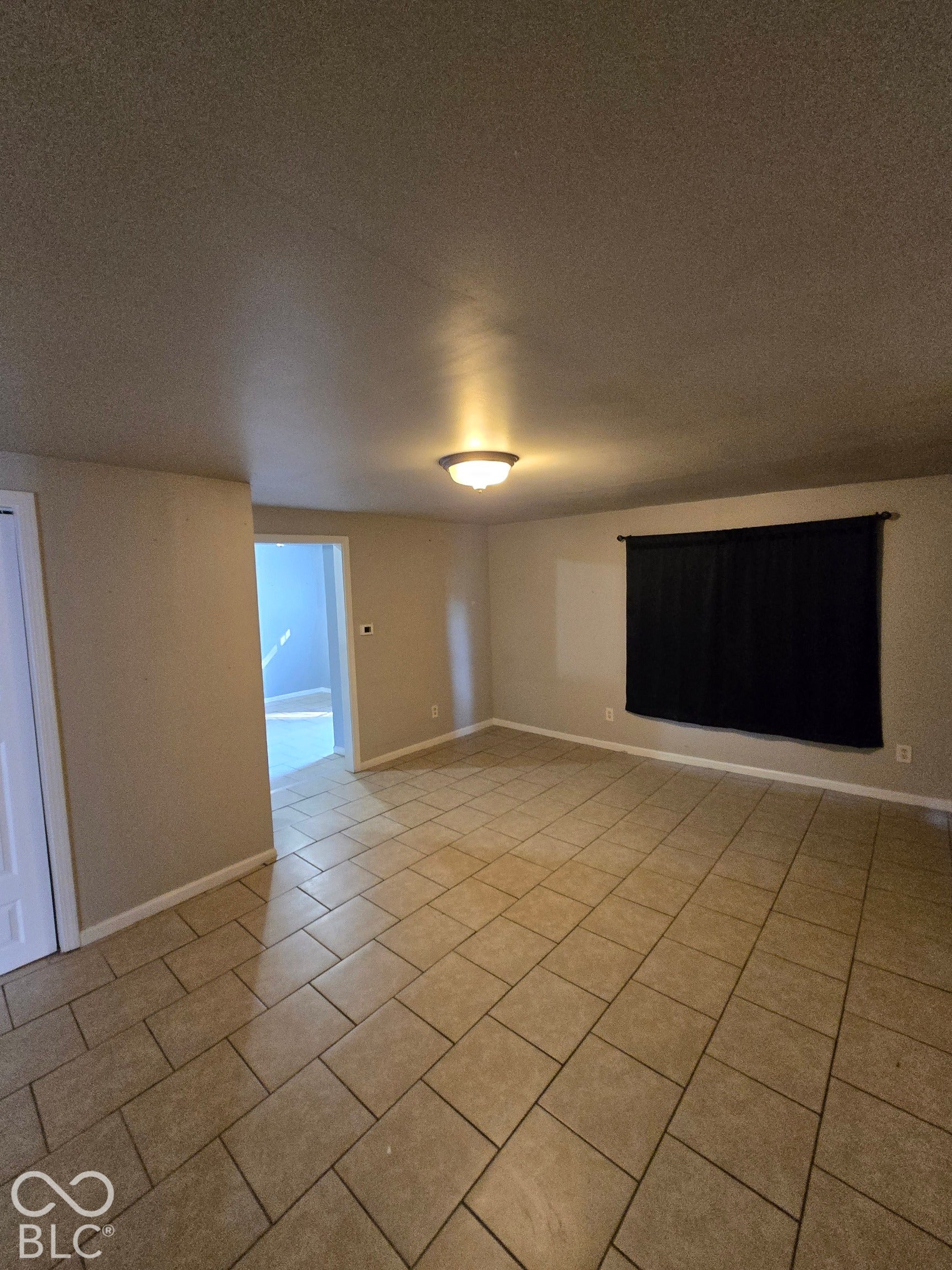 Ceramic tile flooring, neutral wall tones, and recessed lighting