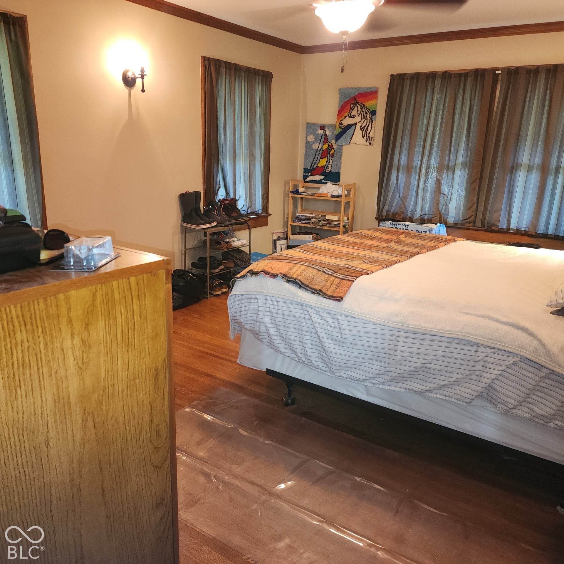 Wood-finish flooring with a ceiling-mounted fan and integrated lighting