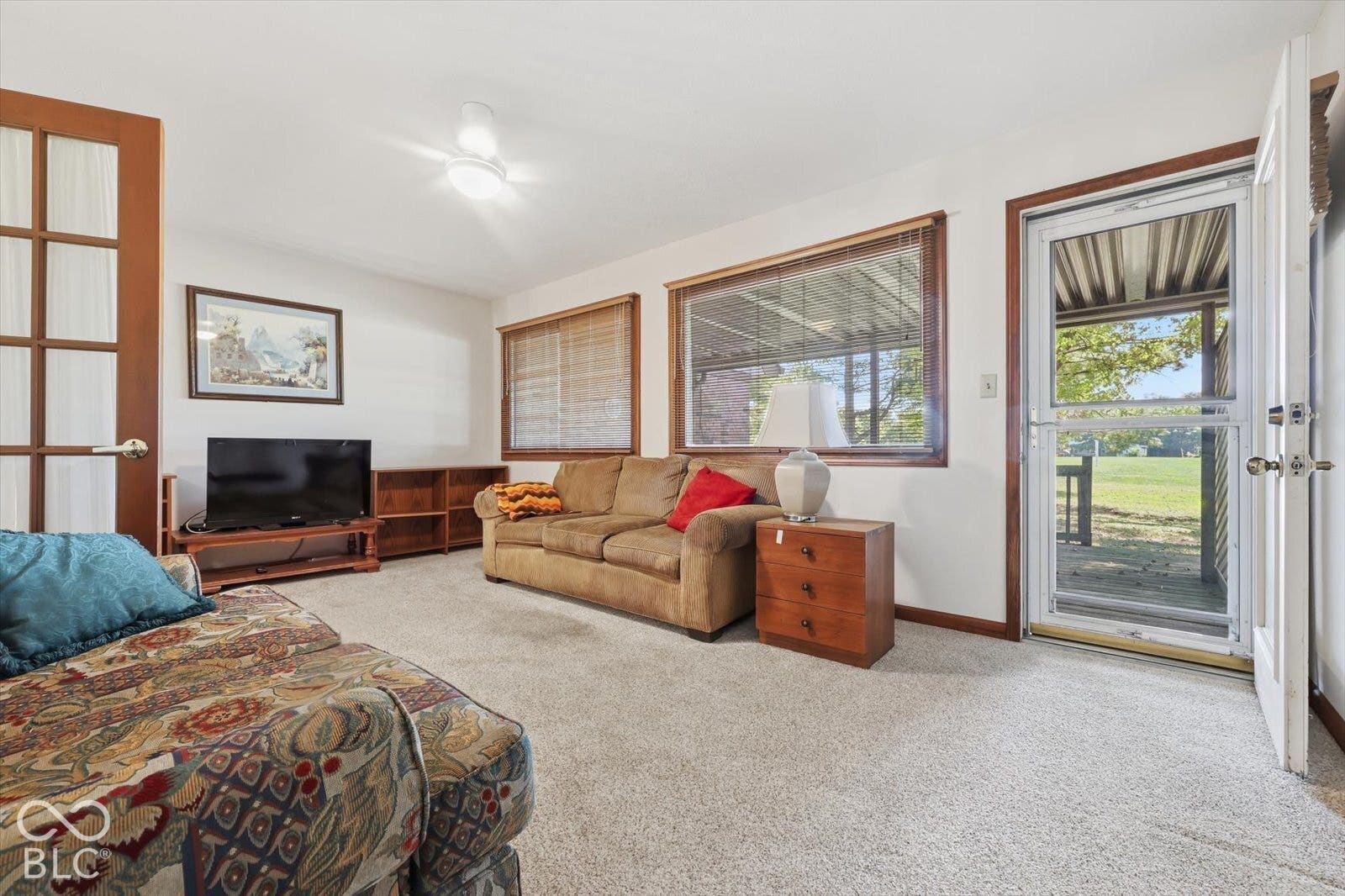 Sun Room featuring wood-trim accents, multiple large windows, a French door, and a glass-paneled exterior door