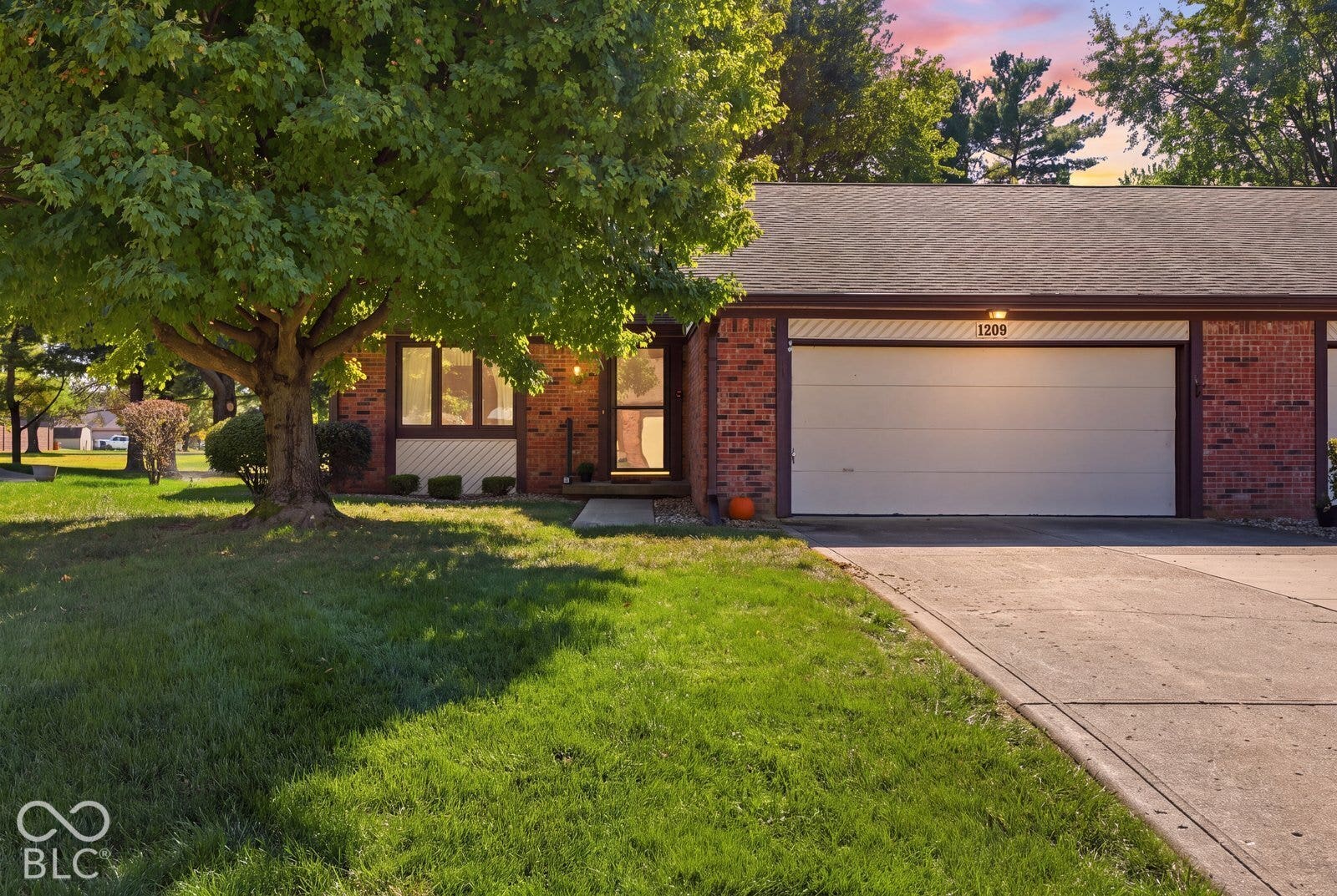 Virtually Altered - Welcome to your New Home- Brick exterior two bedroom , 2 bath residence featuring an attached two-car garage, concrete driveway, and mature landscaping