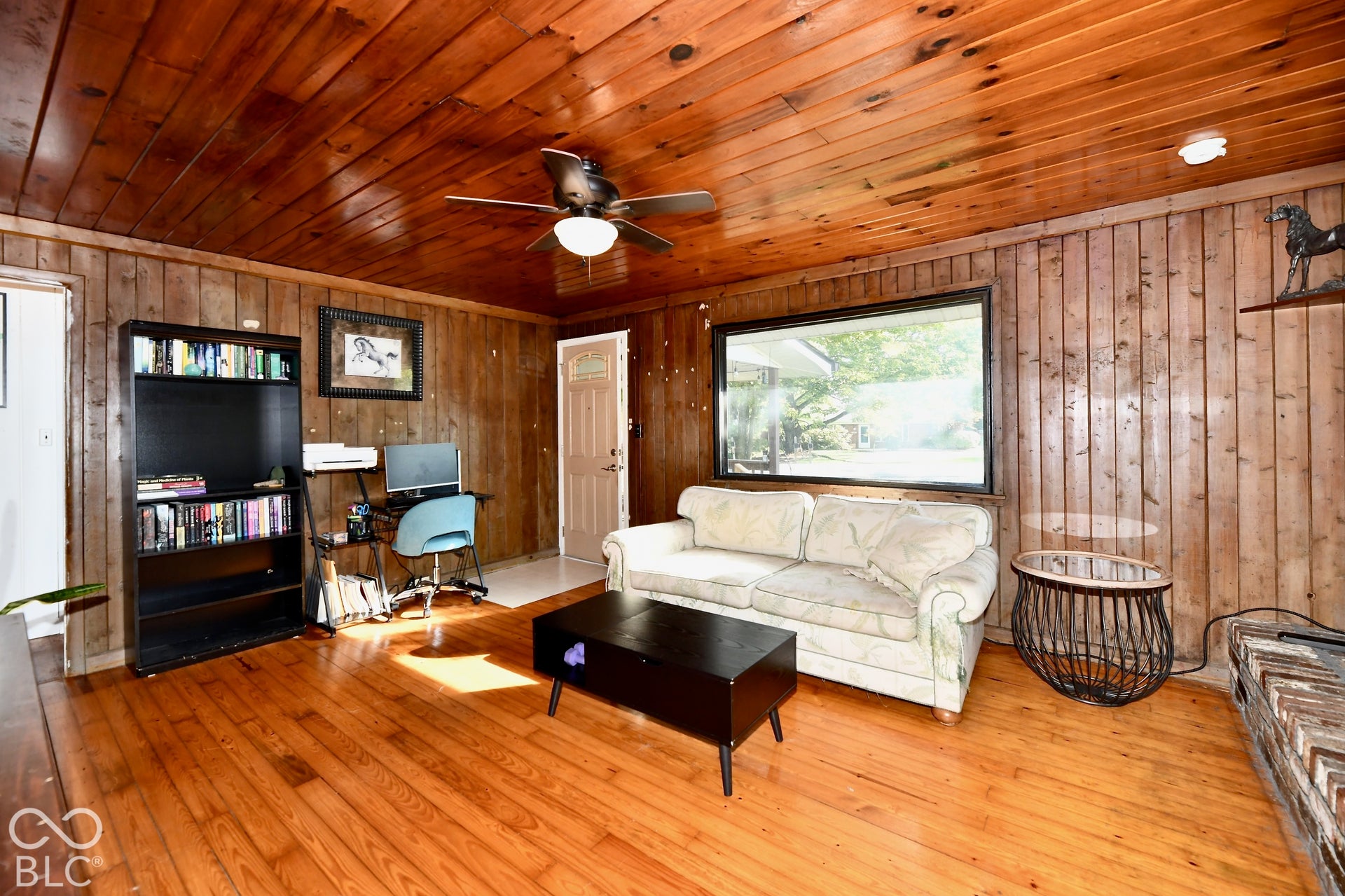 Wood-finish flooring, wood-paneled walls, and wood-paneled ceiling
