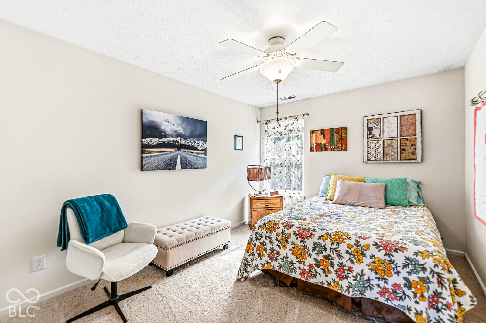 Neutral wall finishes, textured carpeting, and a central ceiling fan with an integrated light fixture