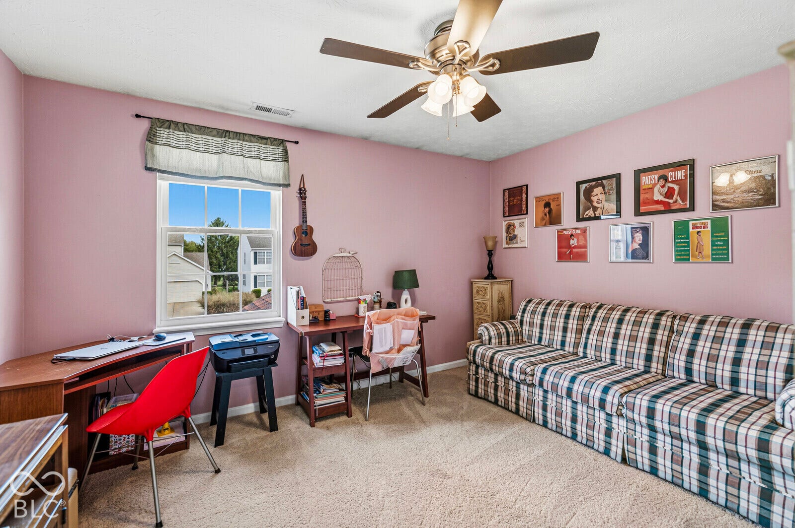 Interior space featuring neutral wall-to-wall carpeting, a multi-blade ceiling fan with integrated lighting, and a double-hung window
