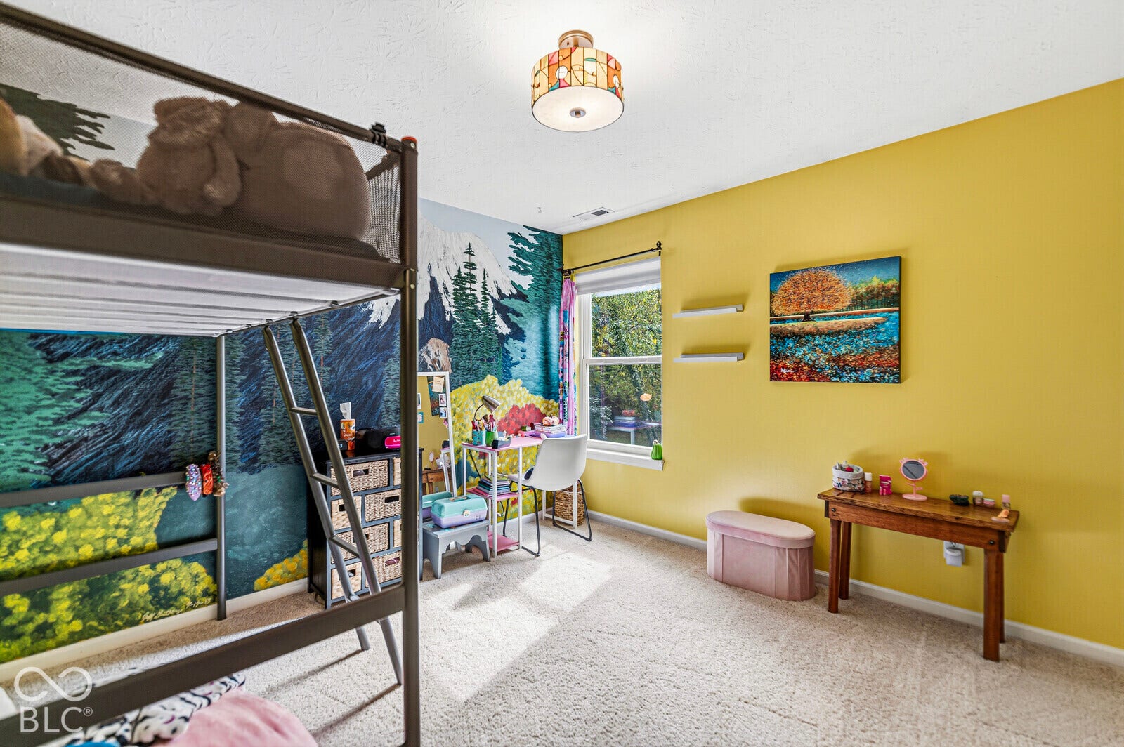 Neutral carpeting, single-hung window, wall-mounted floating shelves, and drum-style ceiling fixture
