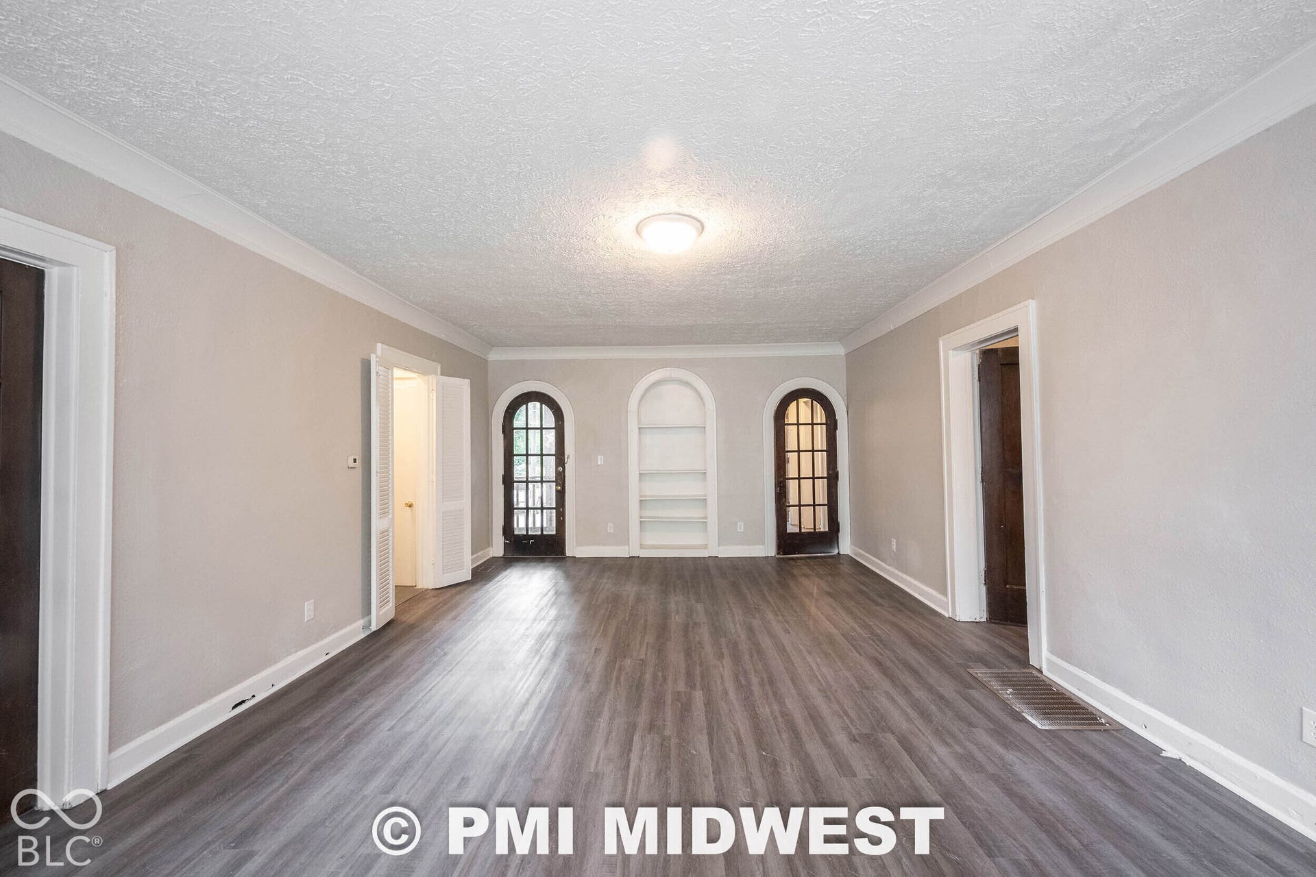 Spacious interior with gray wood-finish flooring