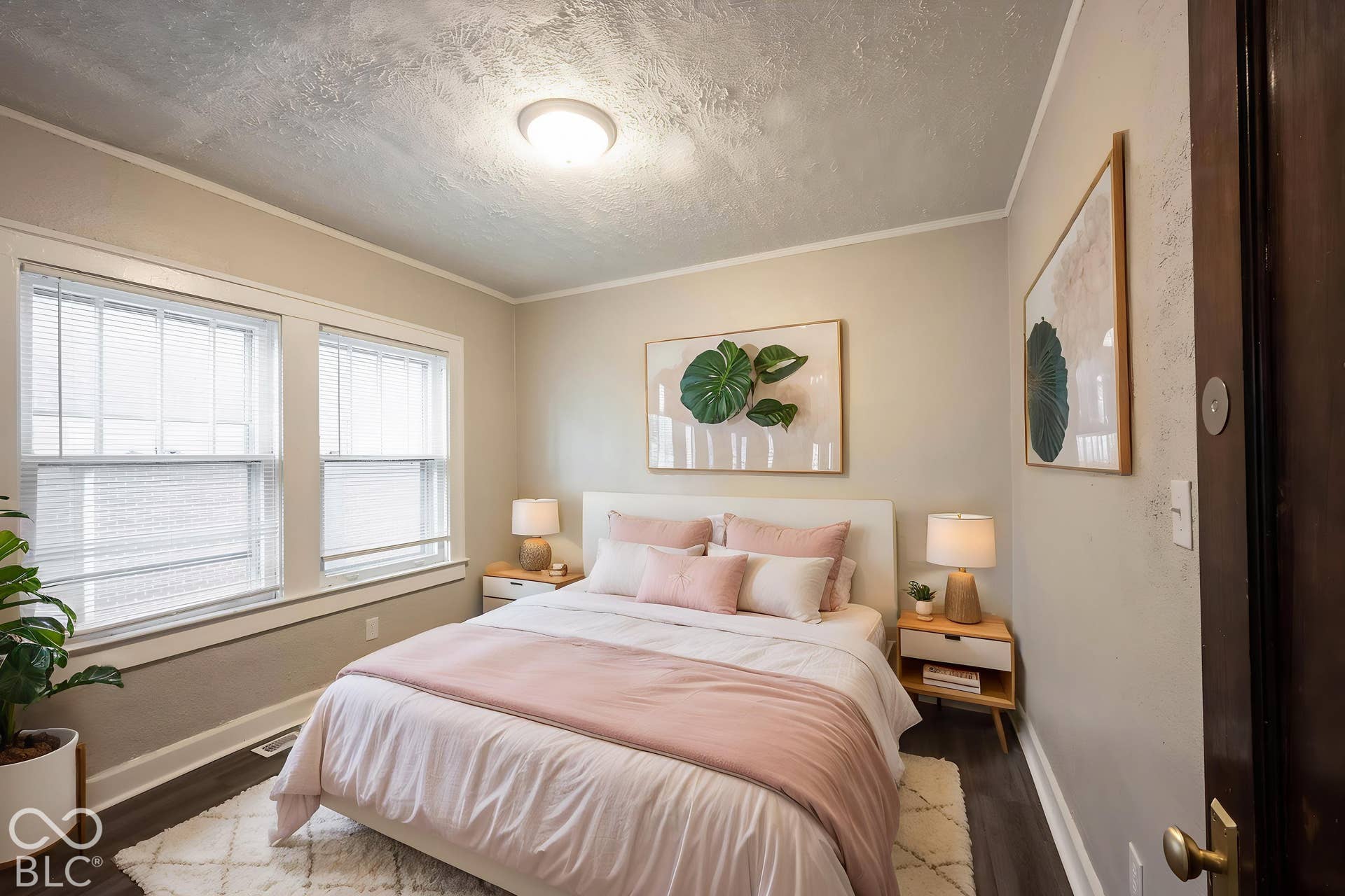 Two windows with white trim, dark wood-finish flooring, and a flush-mount ceiling light