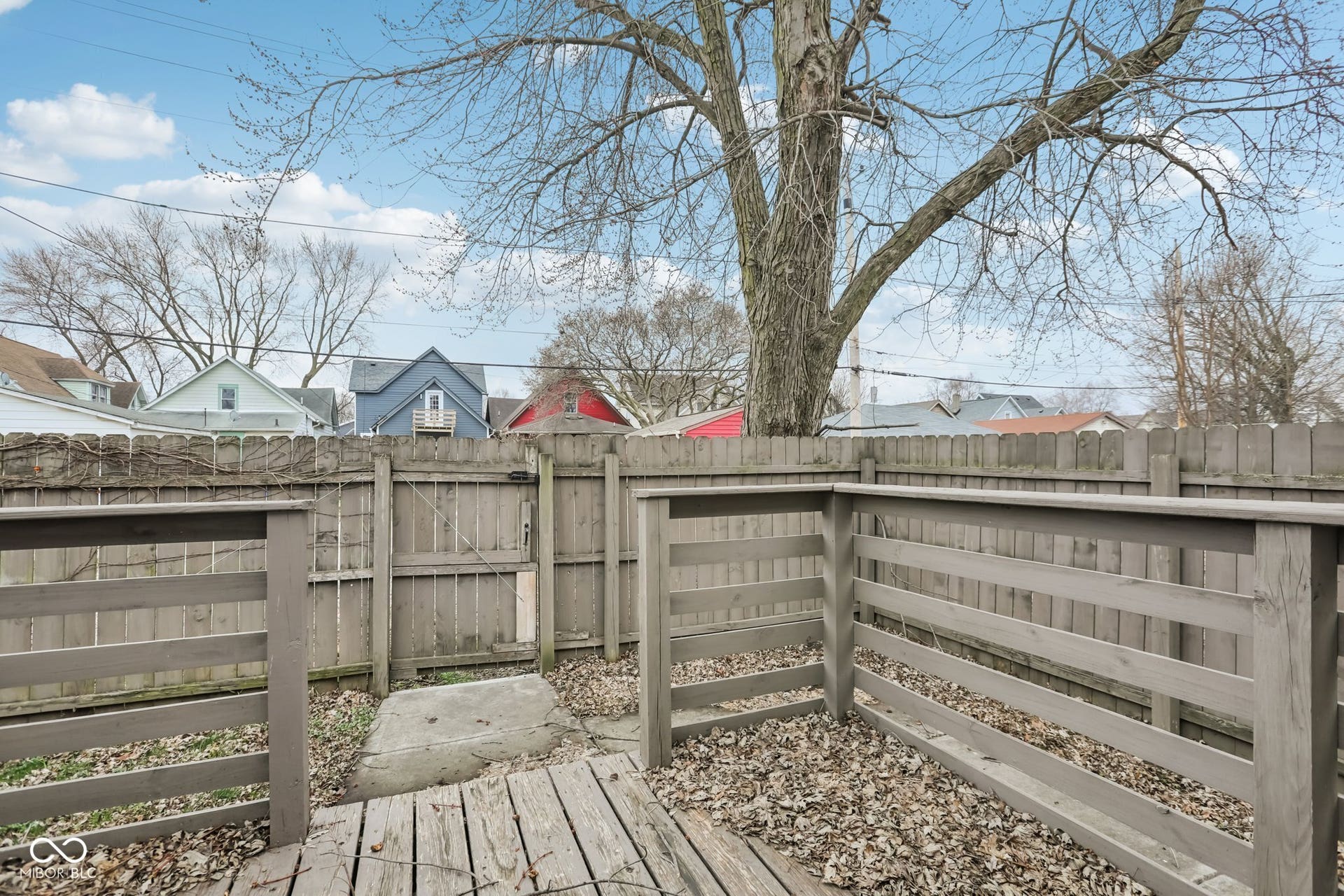 729 E Morris Street, Indianapolis, IN 46203 wooden terrace with a fenced backyard and a gate