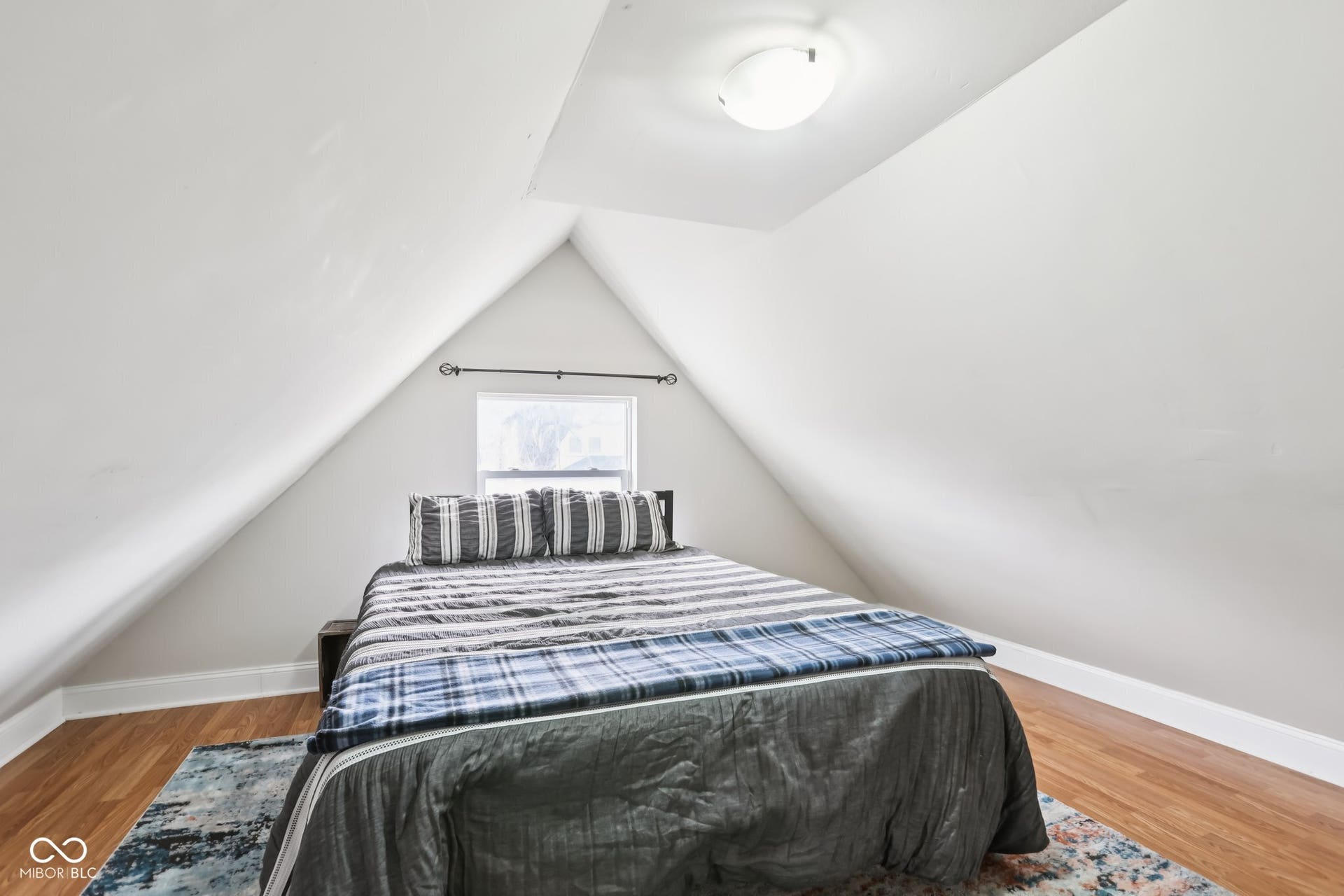 729 E Morris Street, Indianapolis, IN 46203 bedroom featuring baseboards and light wood-type flooring