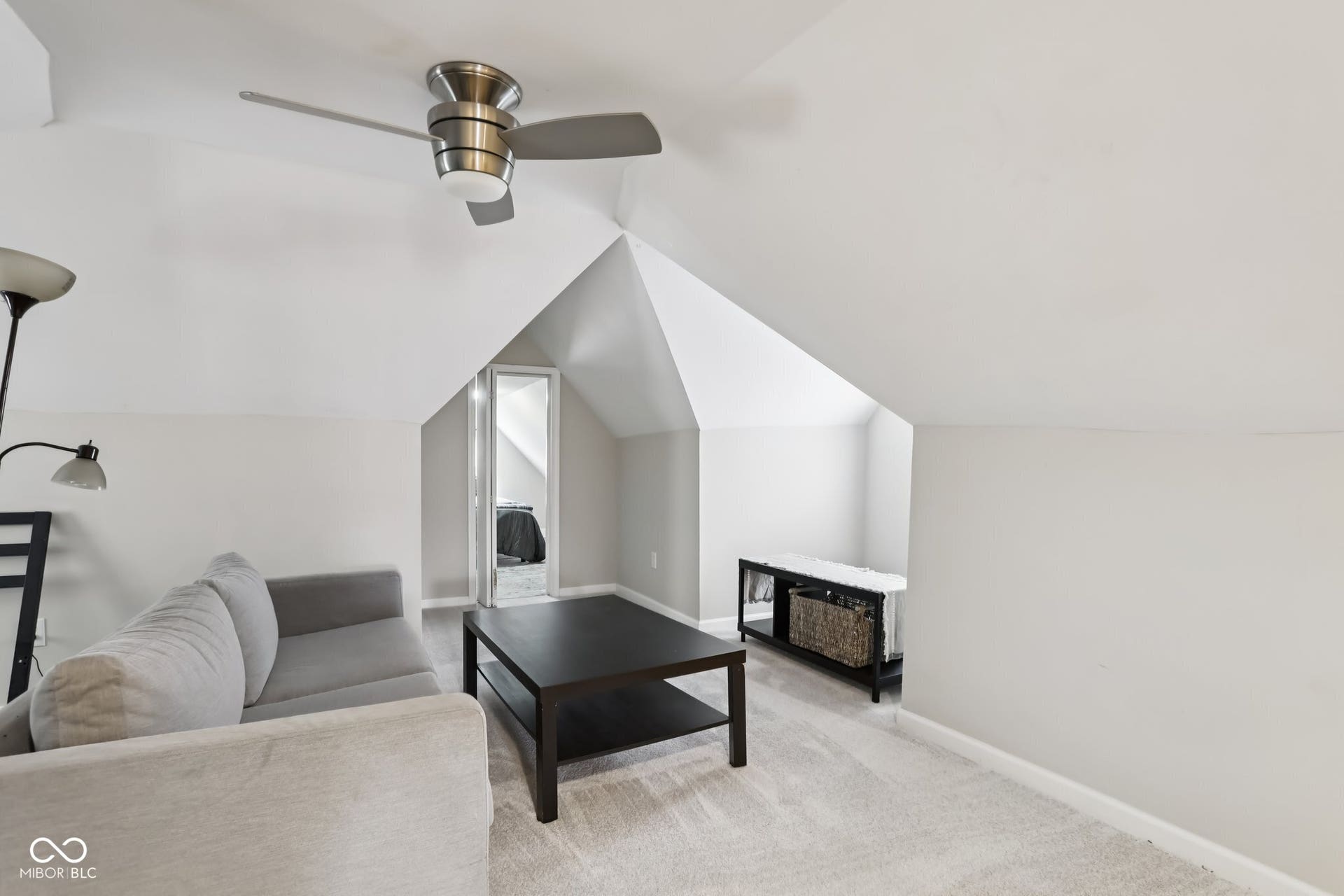 729 E Morris Street, Indianapolis, IN 46203 living room featuring light colored carpet, lofted ceiling, and a ceiling fan