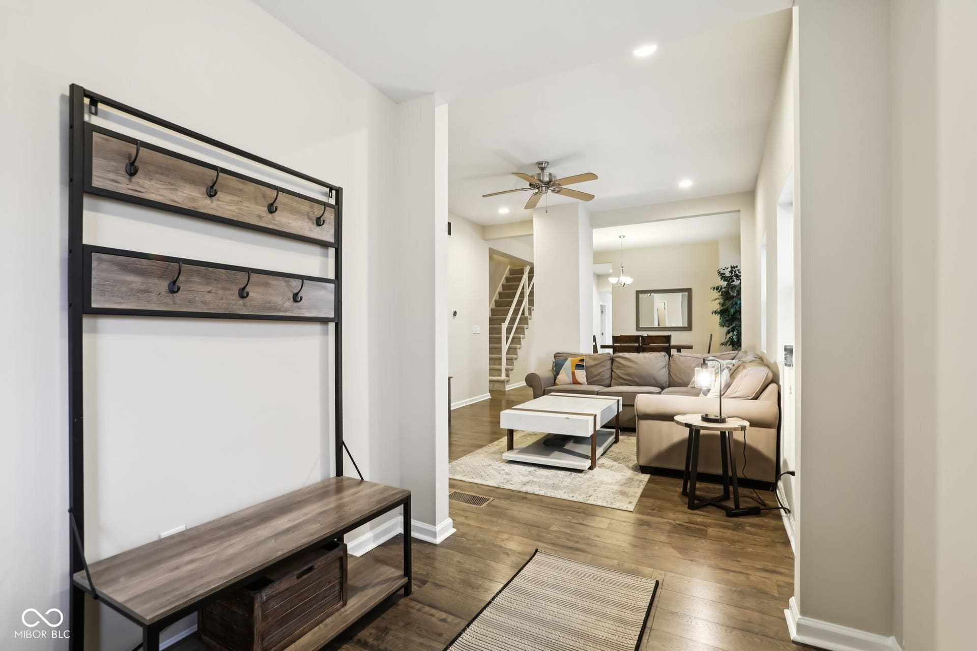 729 E Morris Street, Indianapolis, IN 46203 living area featuring dark wood-style flooring, a ceiling fan, and suspended lighting