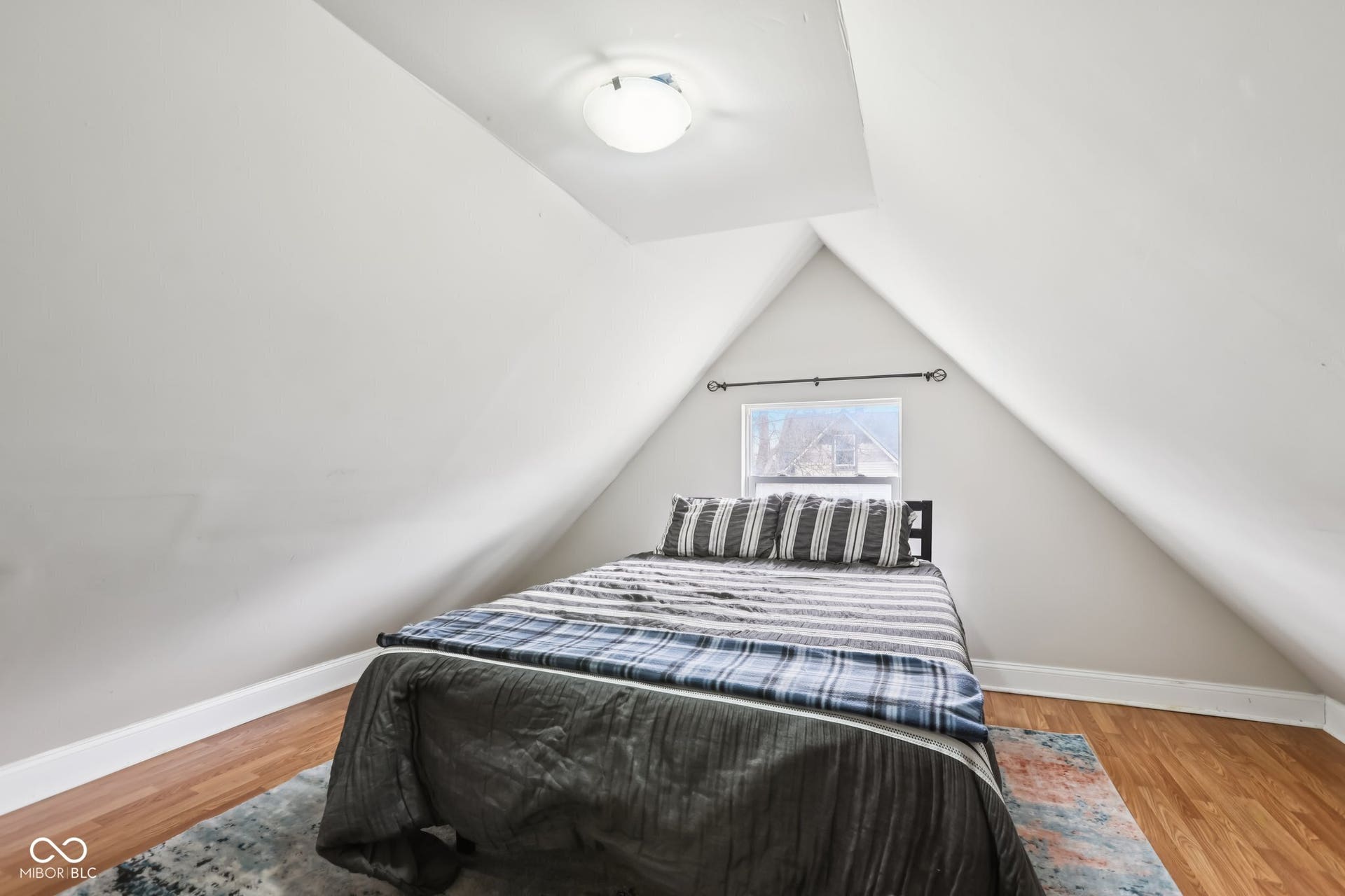 729 E Morris Street, Indianapolis, IN 46203 bedroom featuring baseboards and light wood-style flooring