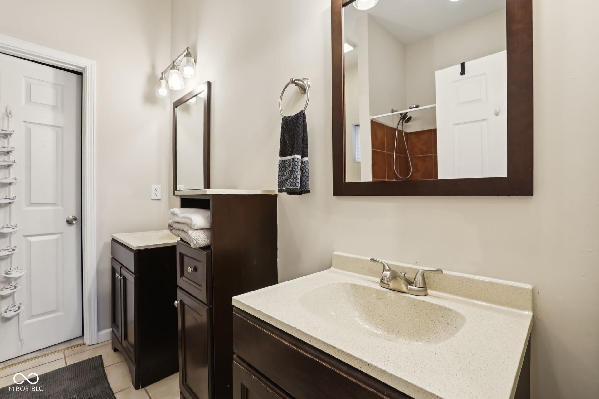 729 E Morris Street, Indianapolis, IN 46203 full bathroom with two vanities, a shower, and light tile patterned floors