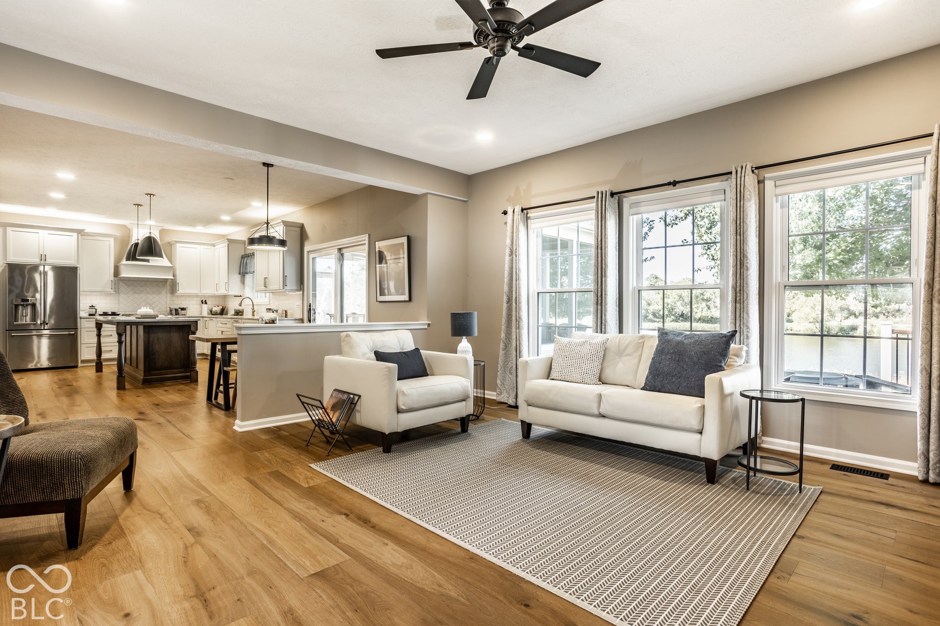 Open-concept living space featuring wood-finish flooring, recessed lighting, and a ceiling fan