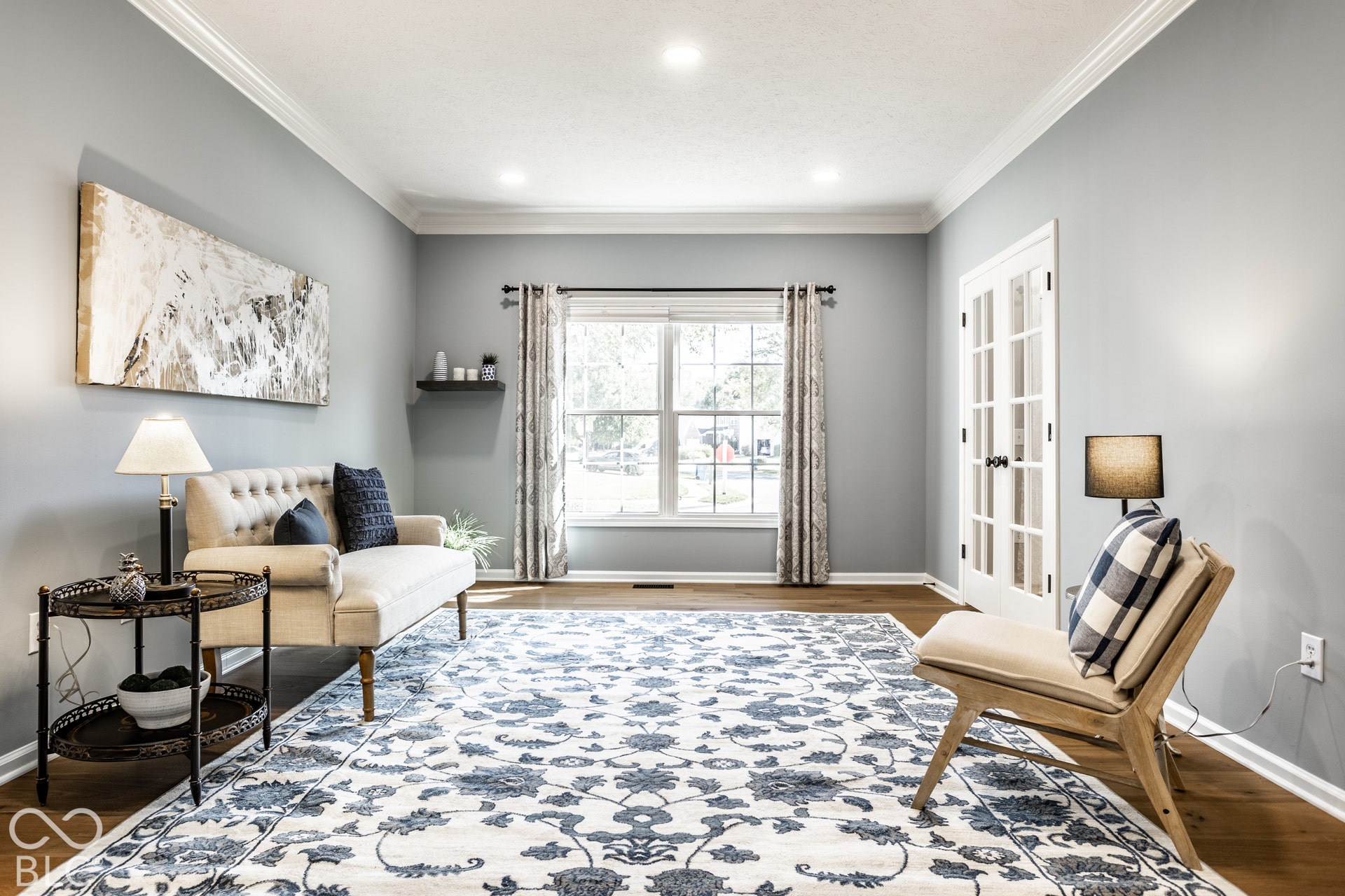 Hardwood flooring, crown molding, recessed lighting, double French doors, and a large window