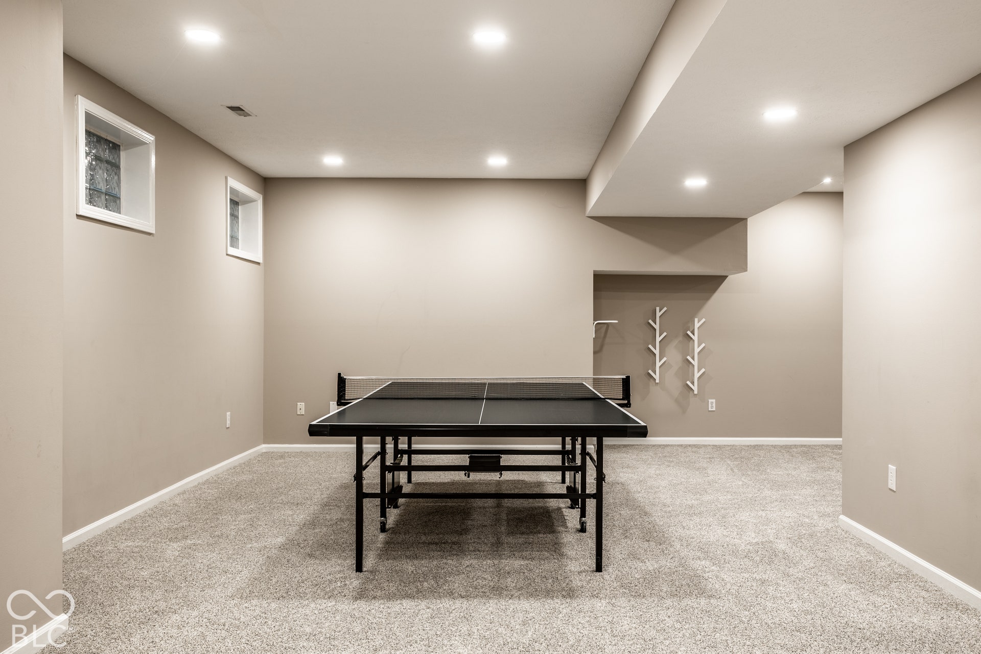 Spacious finished area featuring recessed lighting, a neutral color palette, and carpeted flooring