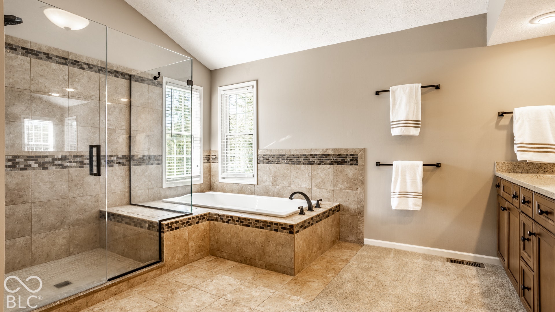 Glass-enclosed shower with a tiled bench