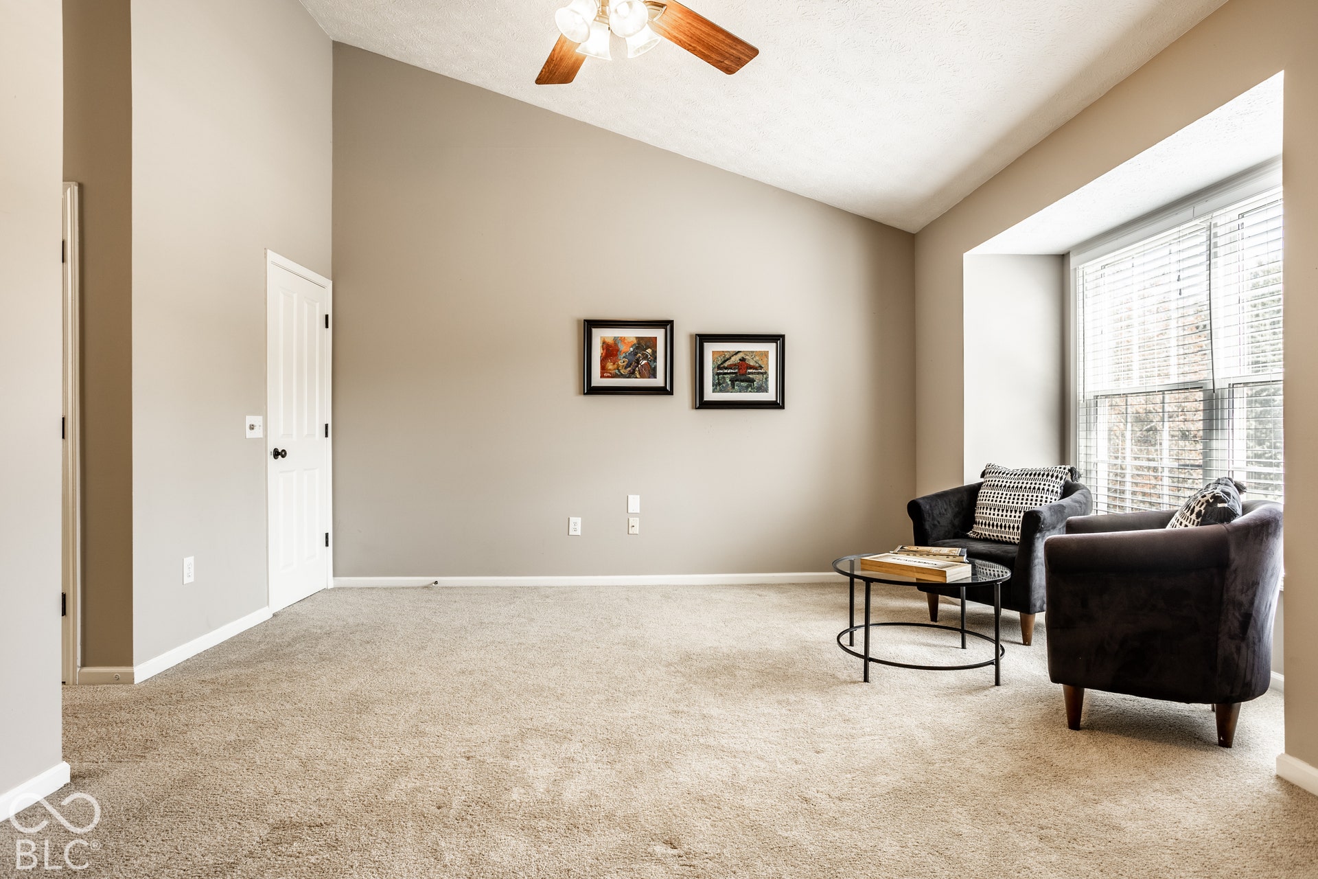 Vaulted ceiling with a ceiling fan, bay window