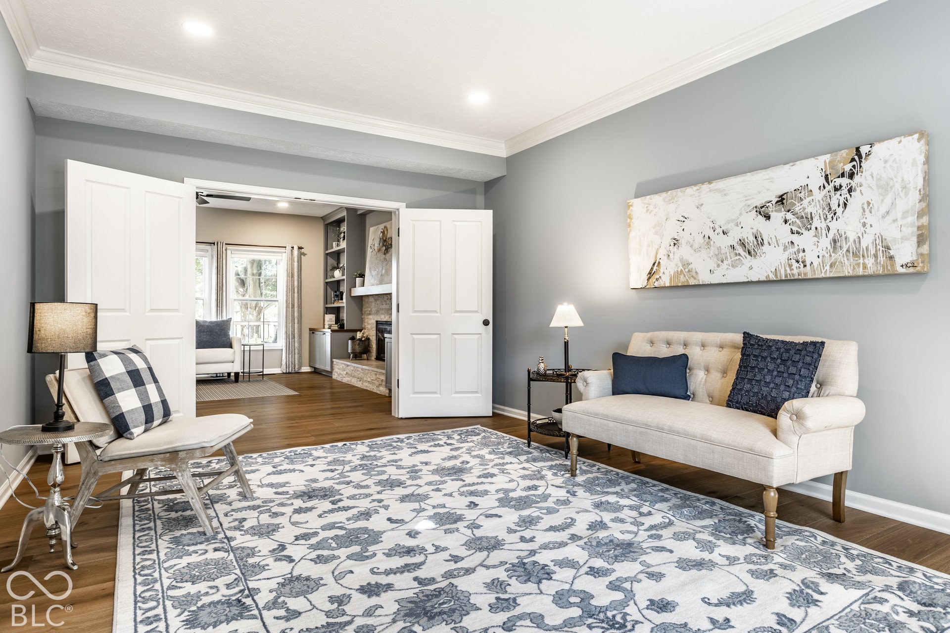 Wood-finish flooring throughout, recessed lighting, crown molding, and double French doors