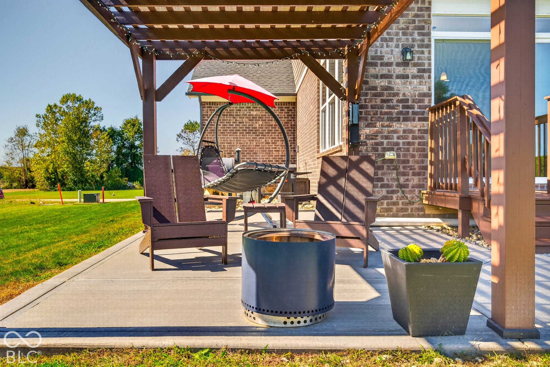 Expansive patio featuring a wood pergola and concrete surfacing