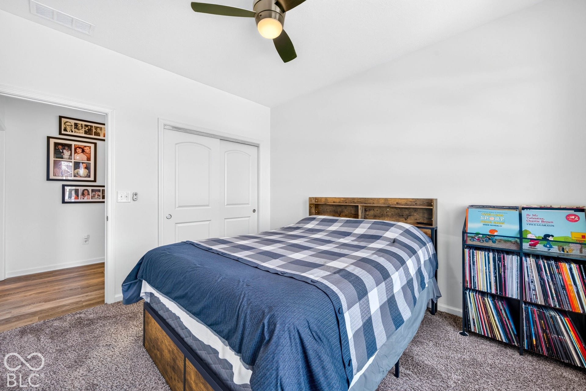 Recessed ceiling fan with integrated lighting, neutral carpet flooring, white walls, and a built-in closet with double doors