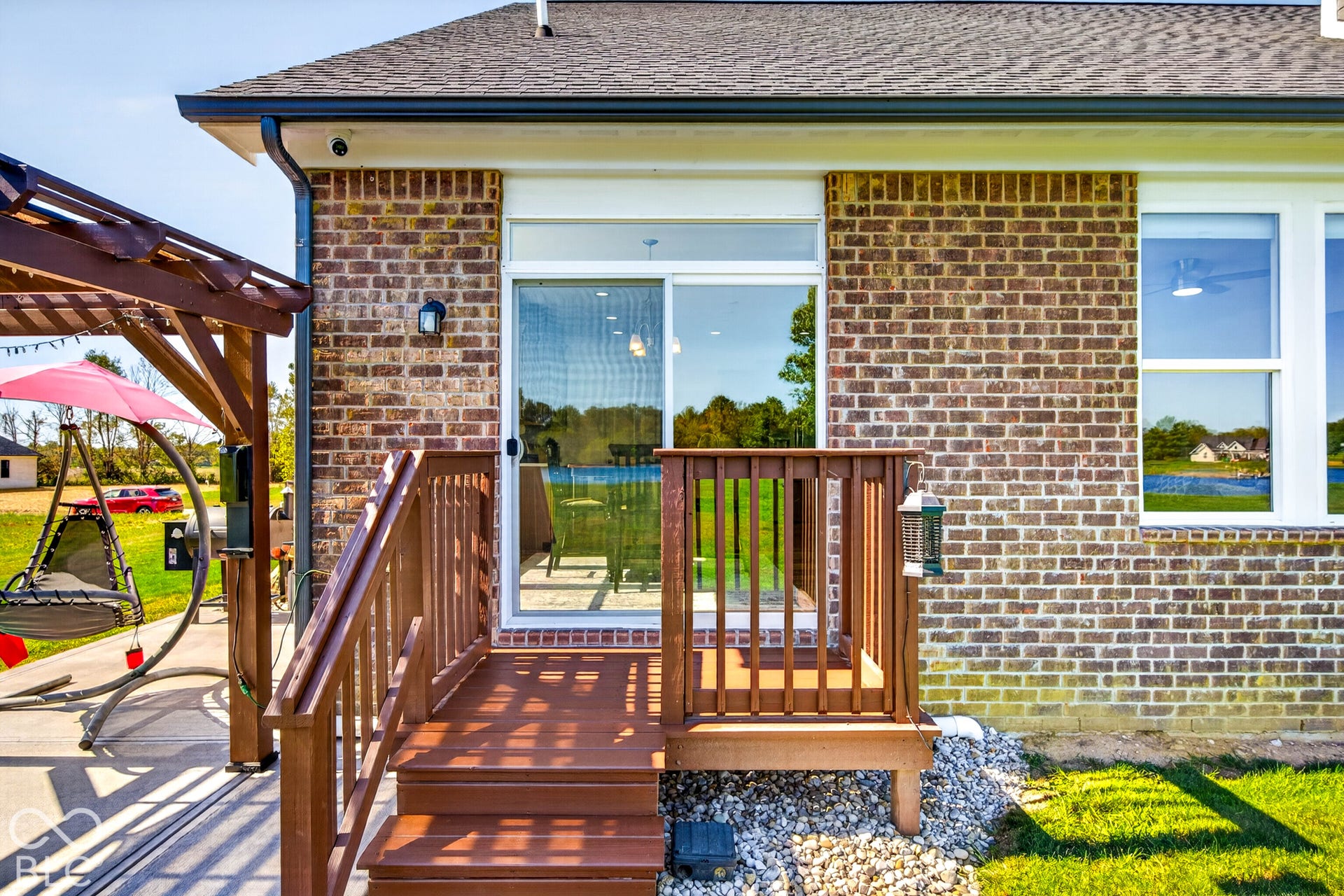 Brick exterior with white-framed windows and sliding glass door