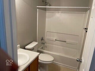 Bathroom featuring a white bathtub, integrated shower, and a white toilet
