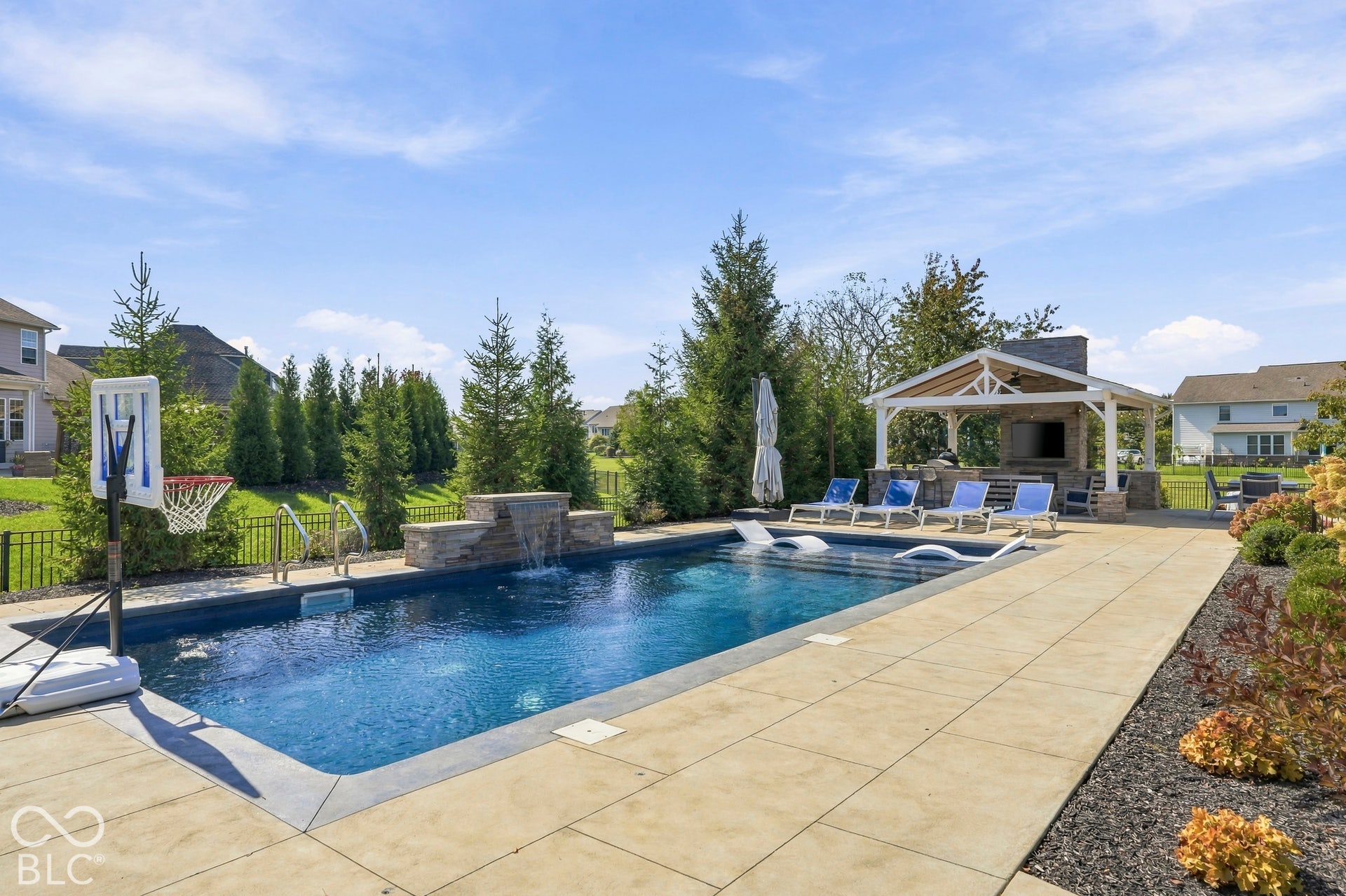 Resort Style Pool and Outdoor Living Pavilion with stone gas fireplace.