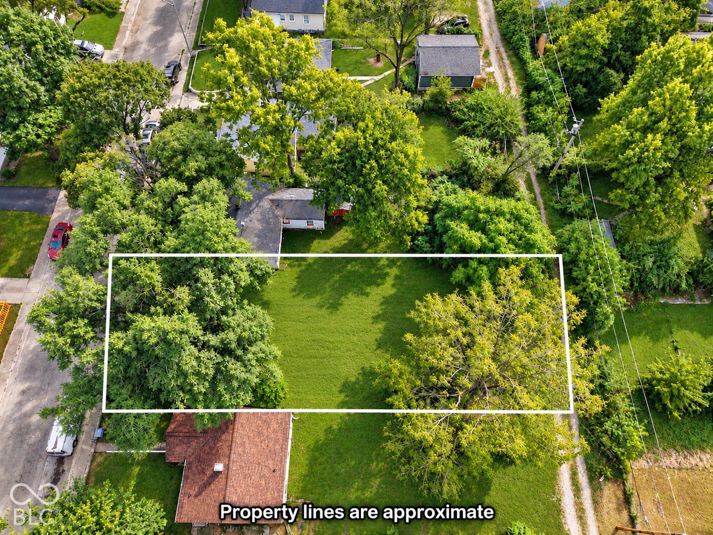Expansive lot featuring mature trees and a substantial grassy area