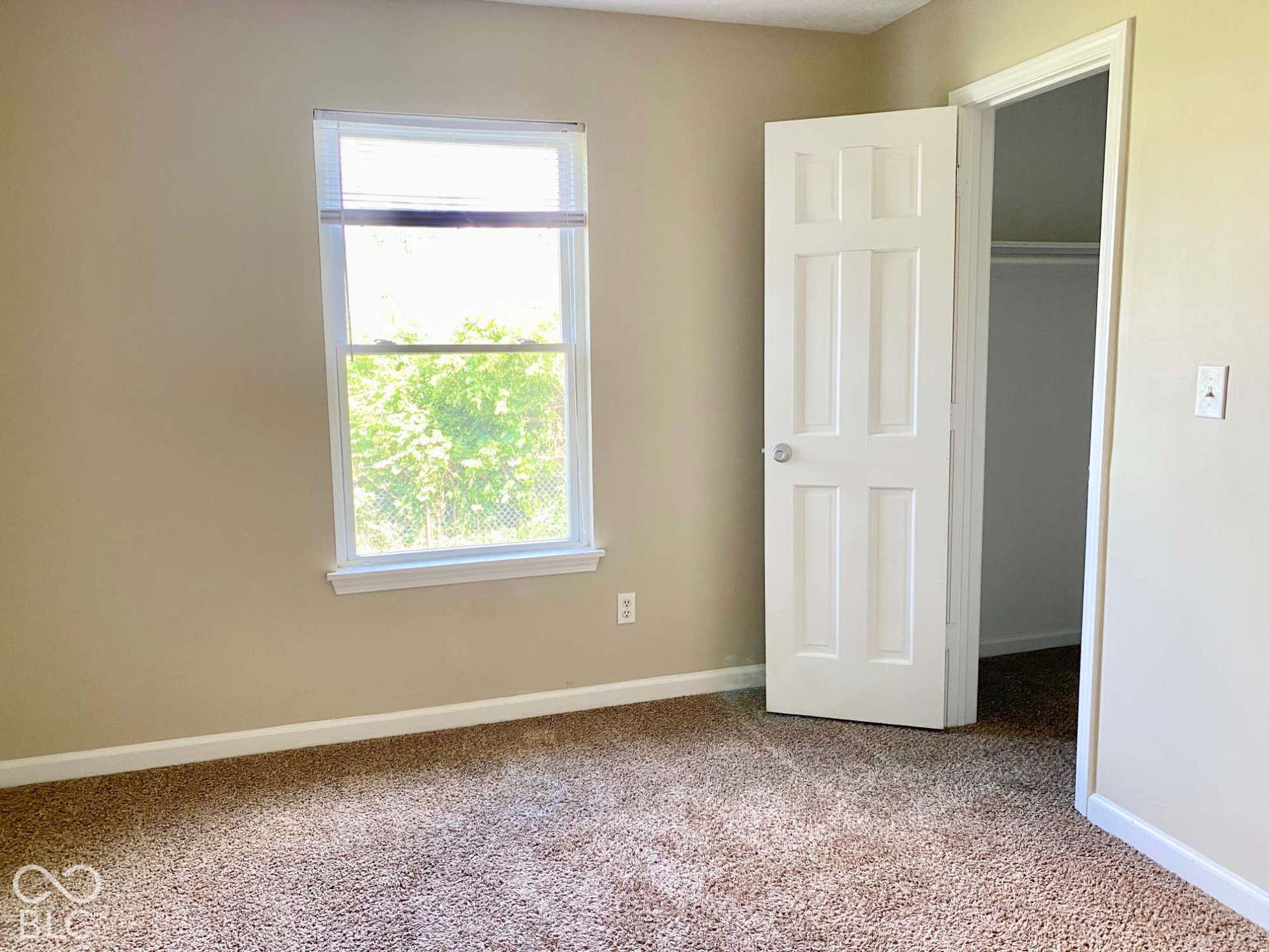 3911 Bonn Drive, Indianapolis, IN 46228 Carpeted flooring, neutral wall paint, white trim, white paneled door, and a white-framed window