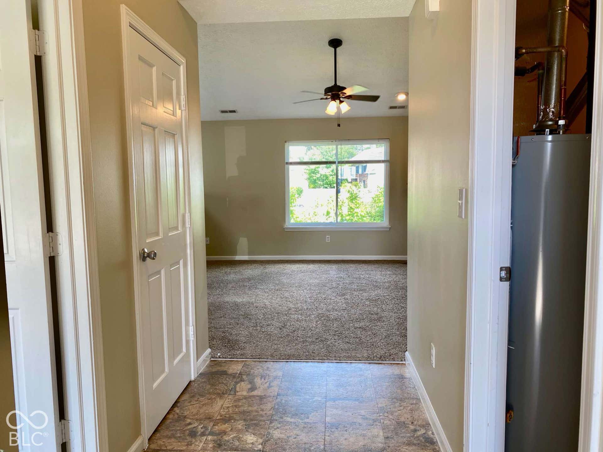 3911 Bonn Drive, Indianapolis, IN 46228 Entryway featuring tiled flooring, opening to a living area with vaulted ceilings and a ceiling fan