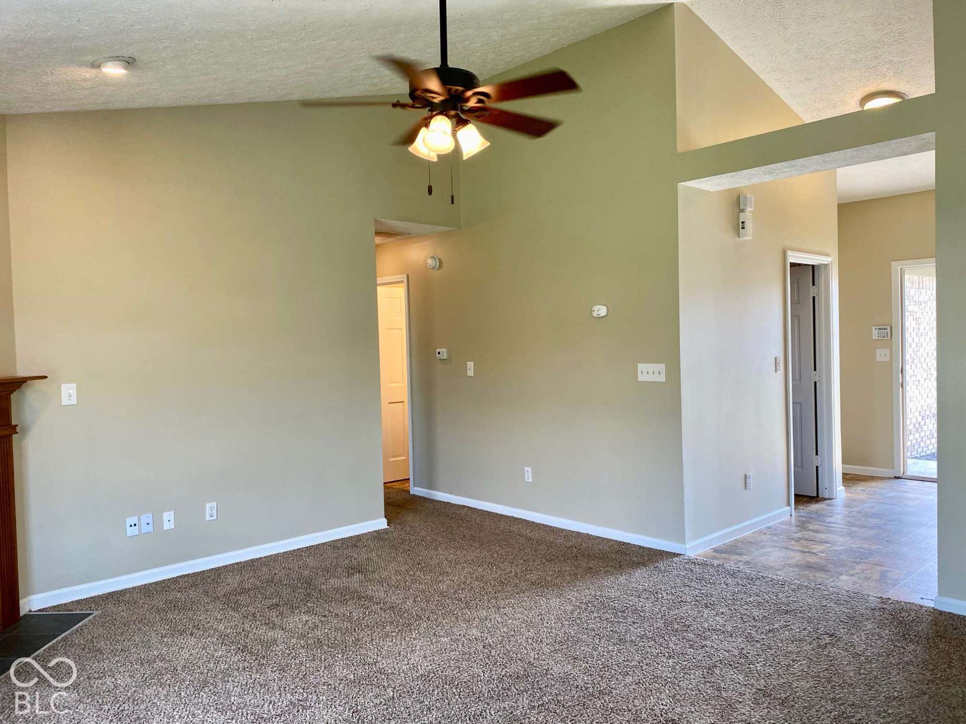 3911 Bonn Drive, Indianapolis, IN 46228 Vaulted ceilings, a ceiling fan with light fixture, recessed lighting, and carpet flooring