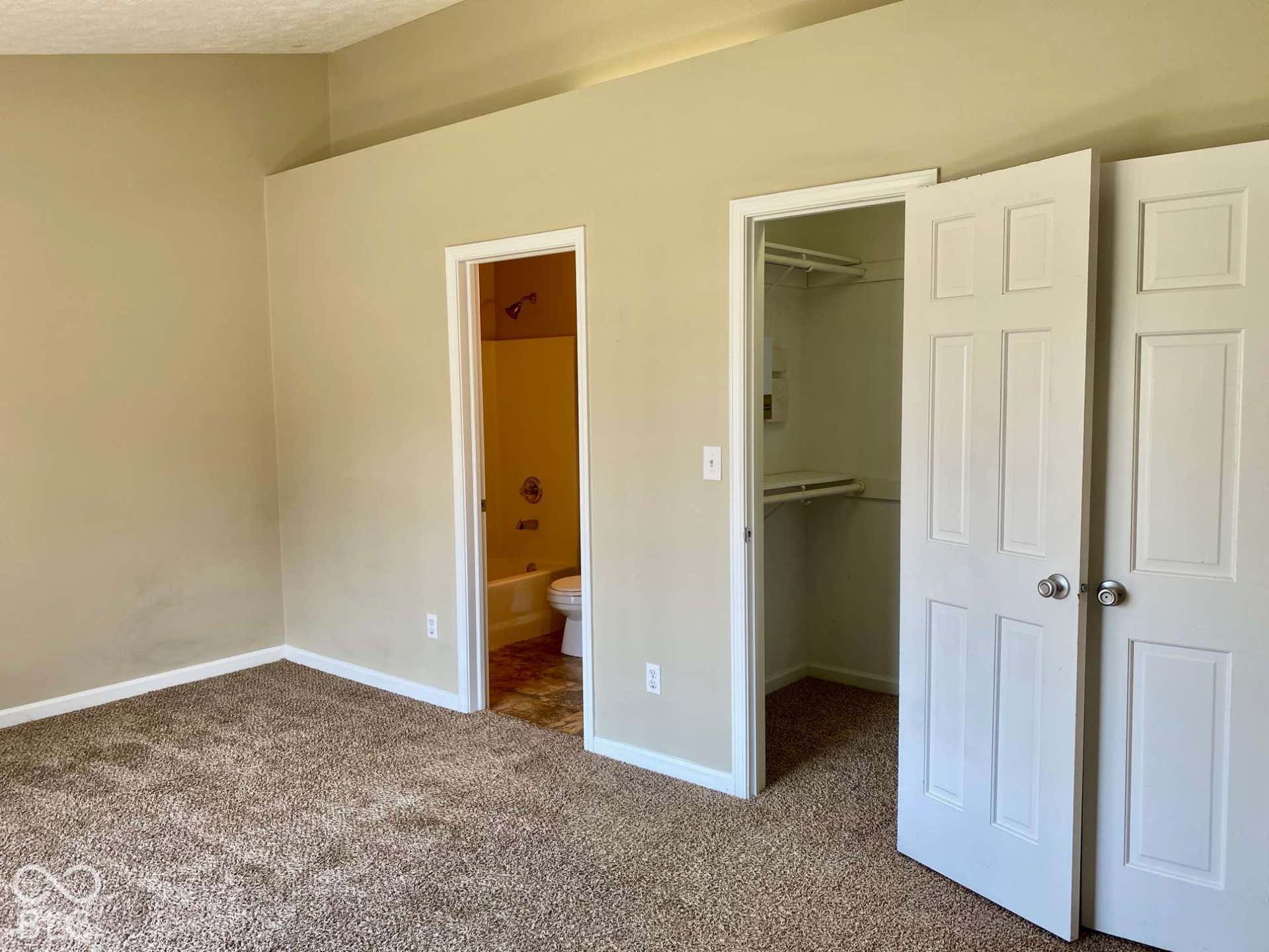 3911 Bonn Drive, Indianapolis, IN 46228 Carpeted flooring, neutral wall paint, white trim, panel doors, and a built-in closet system
