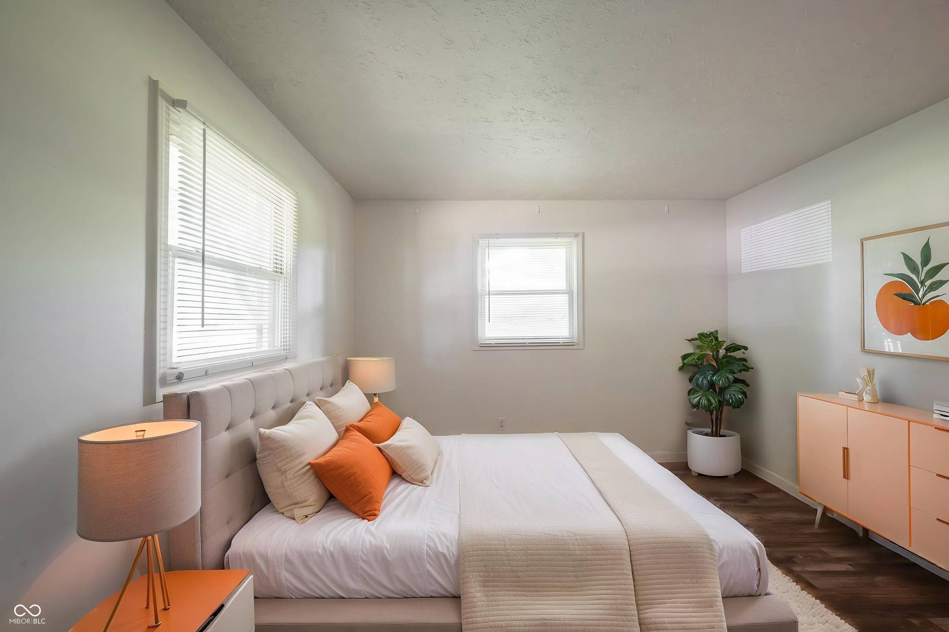 Virtually Altered - Bedroom with multiple windows, wood-finish flooring, and light-toned walls