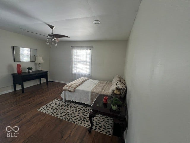 Primary suite with deck access, laminate flooring, ceiling fan with light fixture, window with blinds, recessed lighting, large closet and neutral wall paint