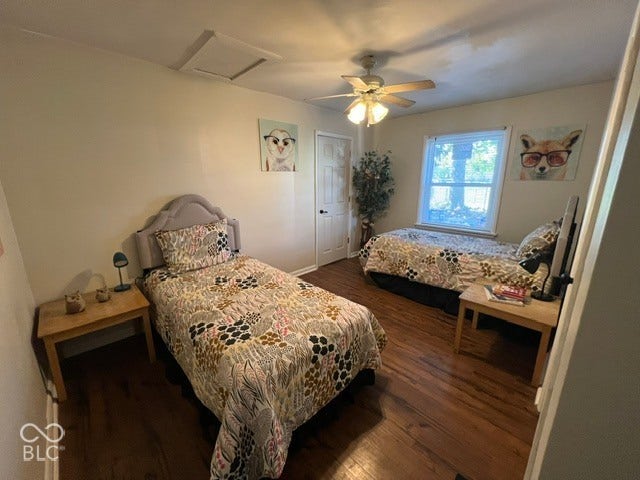 Large third bedroom, laminate flooring, white walls, ceiling fan, white trim window