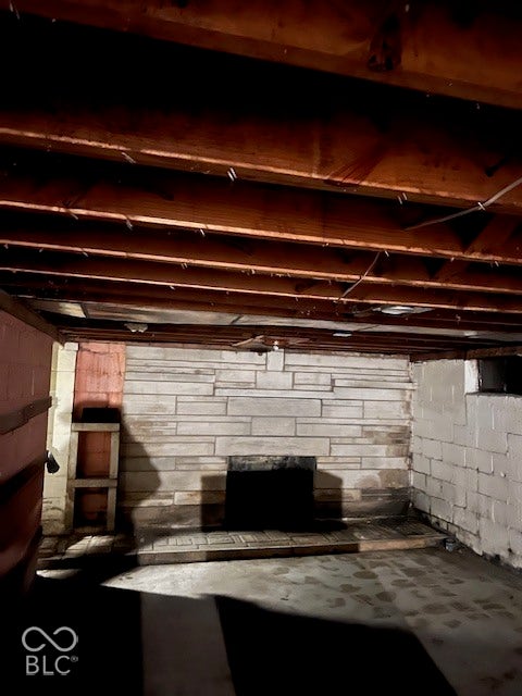 Unfinished basement with fireplace