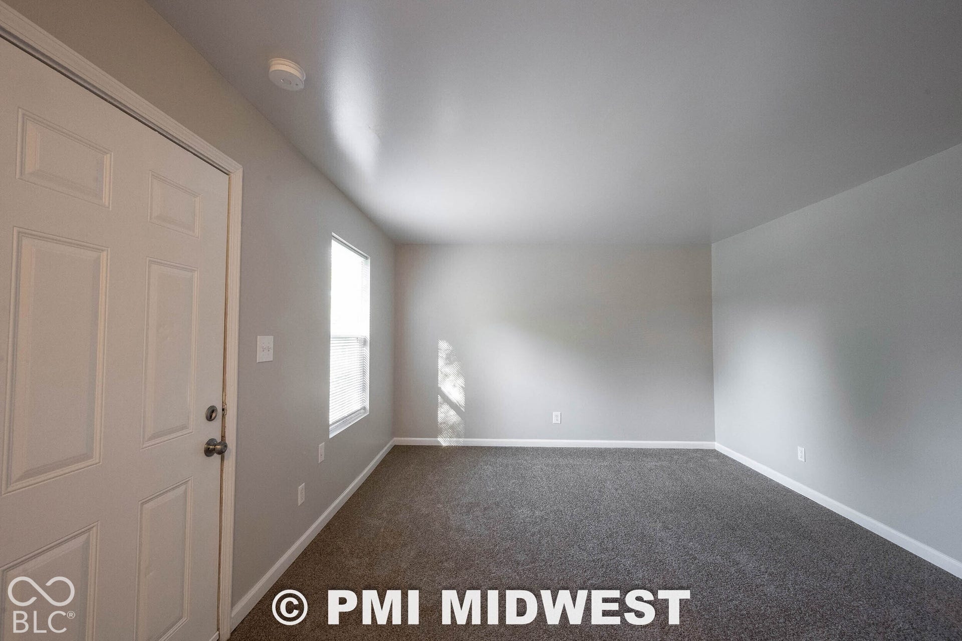 1122 Congress Avenue, Indianapolis, IN 46208 Neutral wall tones, gray carpeting, and a single window