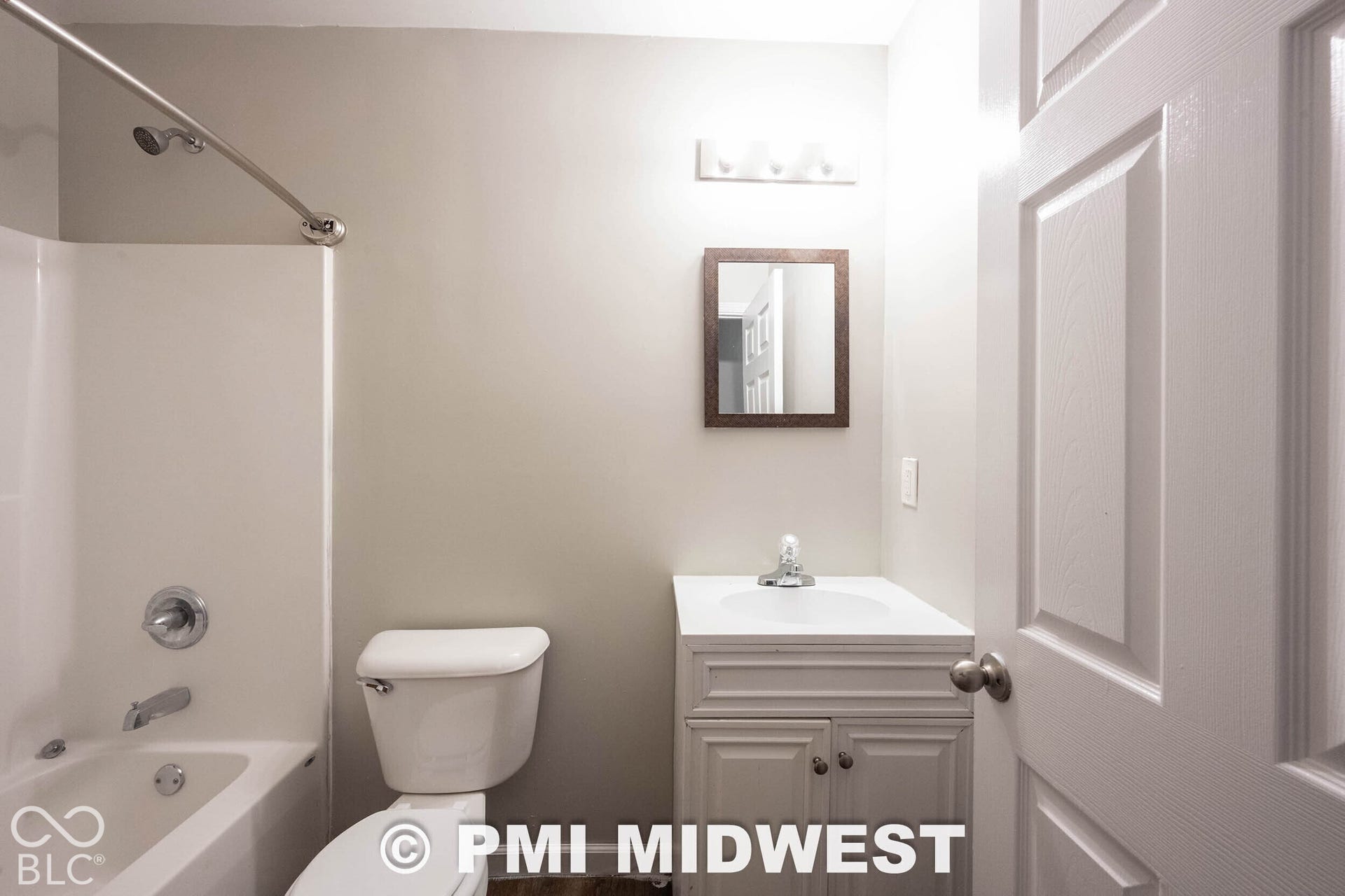1122 Congress Avenue, Indianapolis, IN 46208 White vanity with integrated sink, chrome fixtures, and a framed mirror