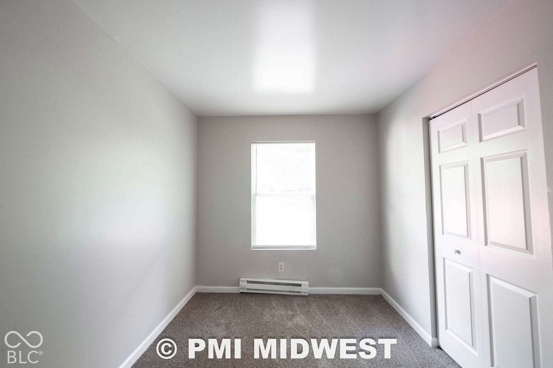 1122 Congress Avenue, Indianapolis, IN 46208 Carpeted flooring, window with blinds, bi-fold closet doors, baseboard heating unit
