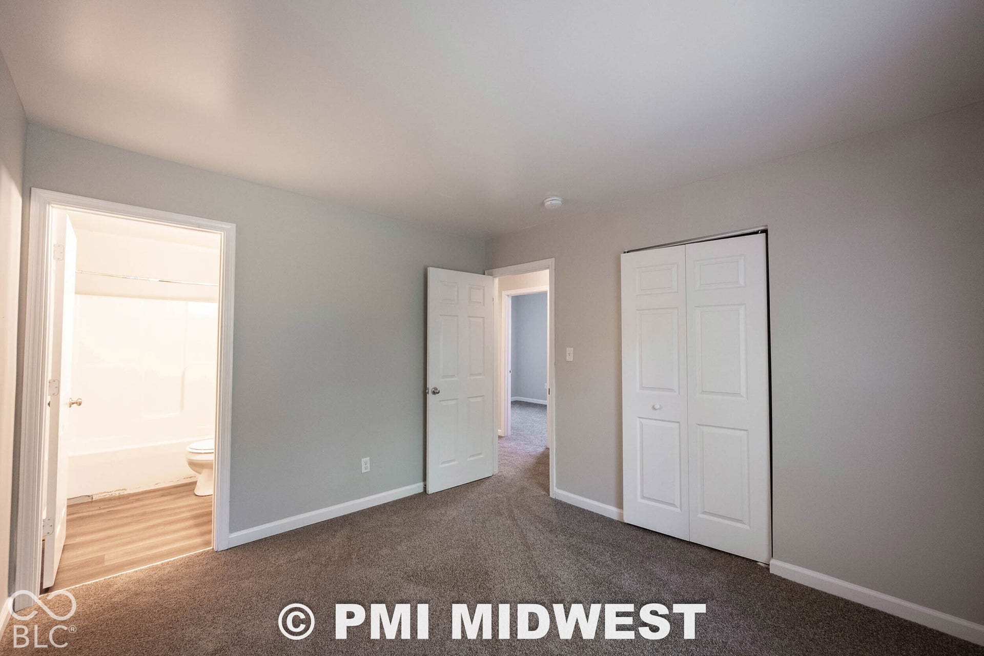 1122 Congress Avenue, Indianapolis, IN 46208 Plush carpeted flooring, light gray wall paint, white trim, and a white bi-fold closet door